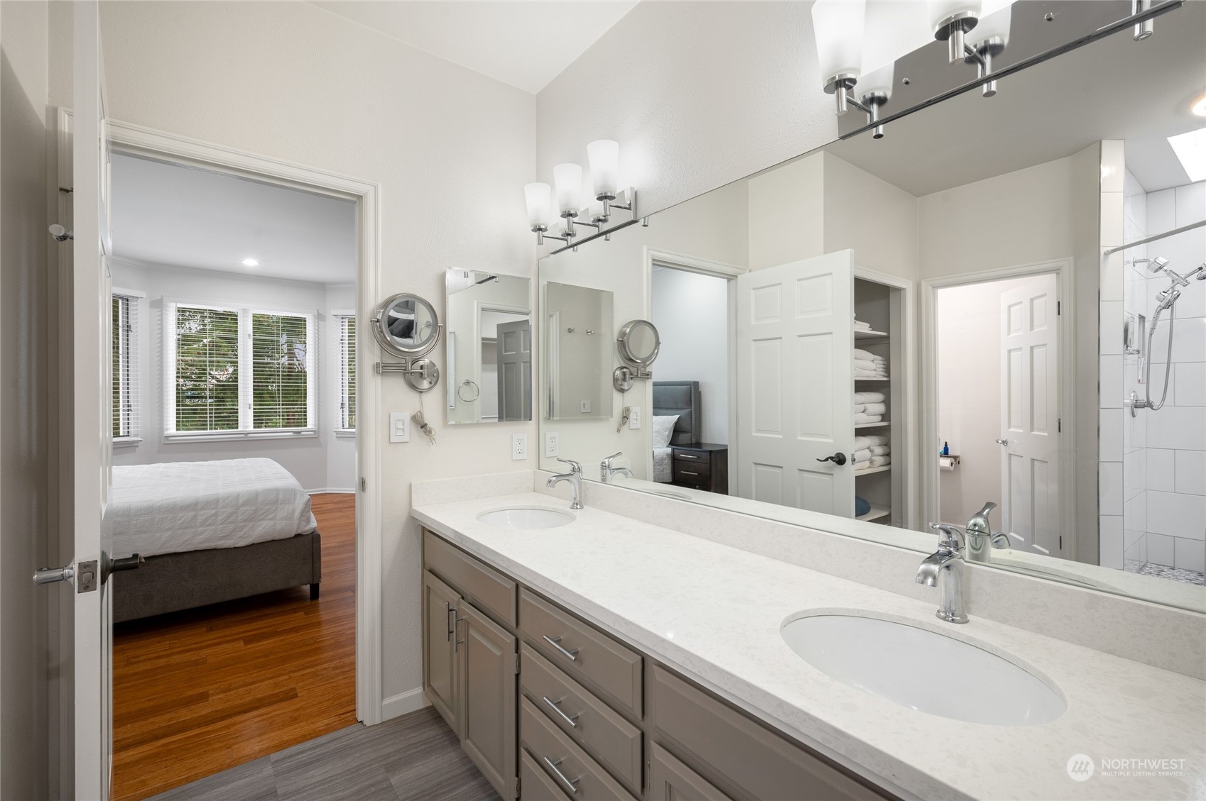 Primary bath has storage, large walk-in closet and skylight.