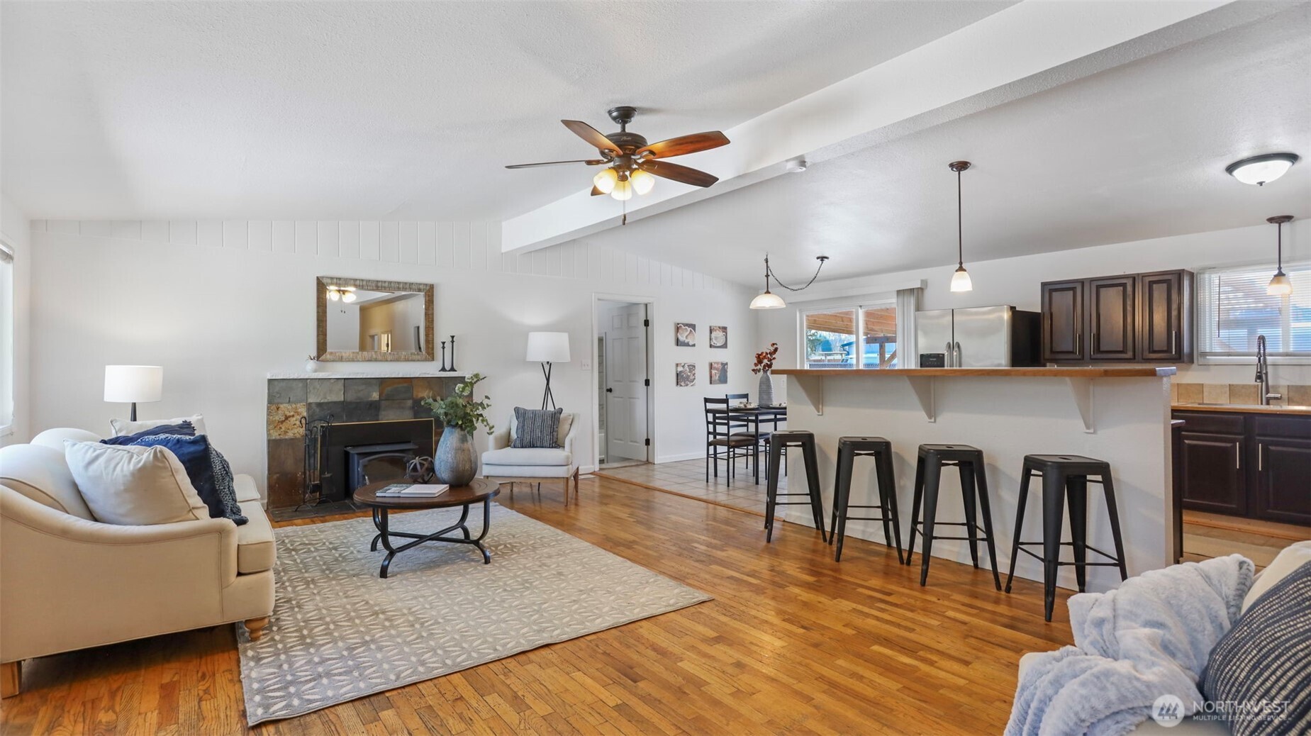 This living space offers vaulted ceilings, light and bright interiors and a cozy wood-burning fireplace.