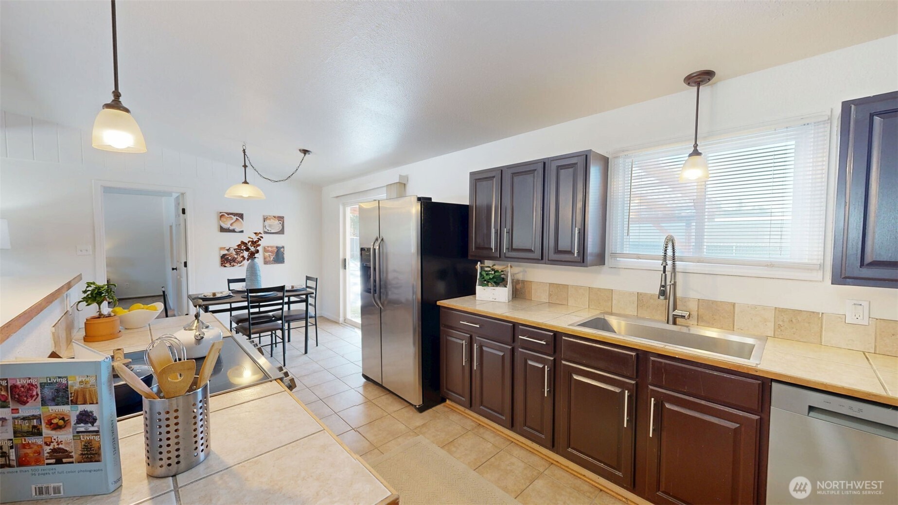 Kitchen has a quaint dining space with direct access to the covered back patio for easy indoor outdoor living.