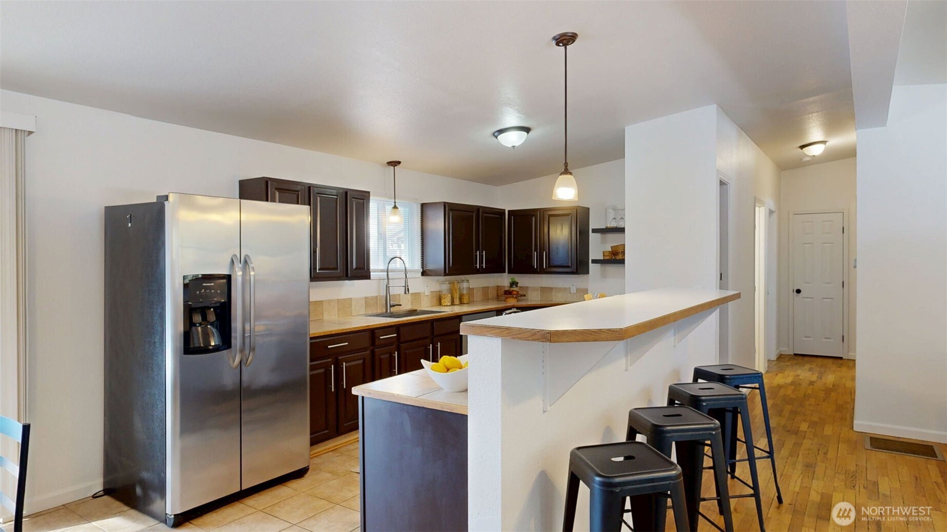 The spacious kitchen offers ample cabinet & counter space, large single basin sink, and window looking out to the backyard.