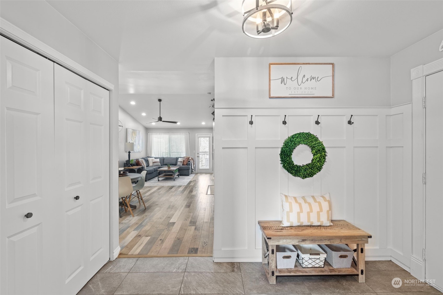 Warm and inviting entry with new flooring and light fixtures.