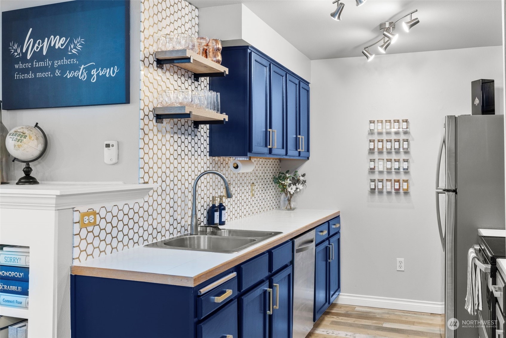 Stylish kitchen updated with painted cabinets, full height backsplash and stainless steel appliances