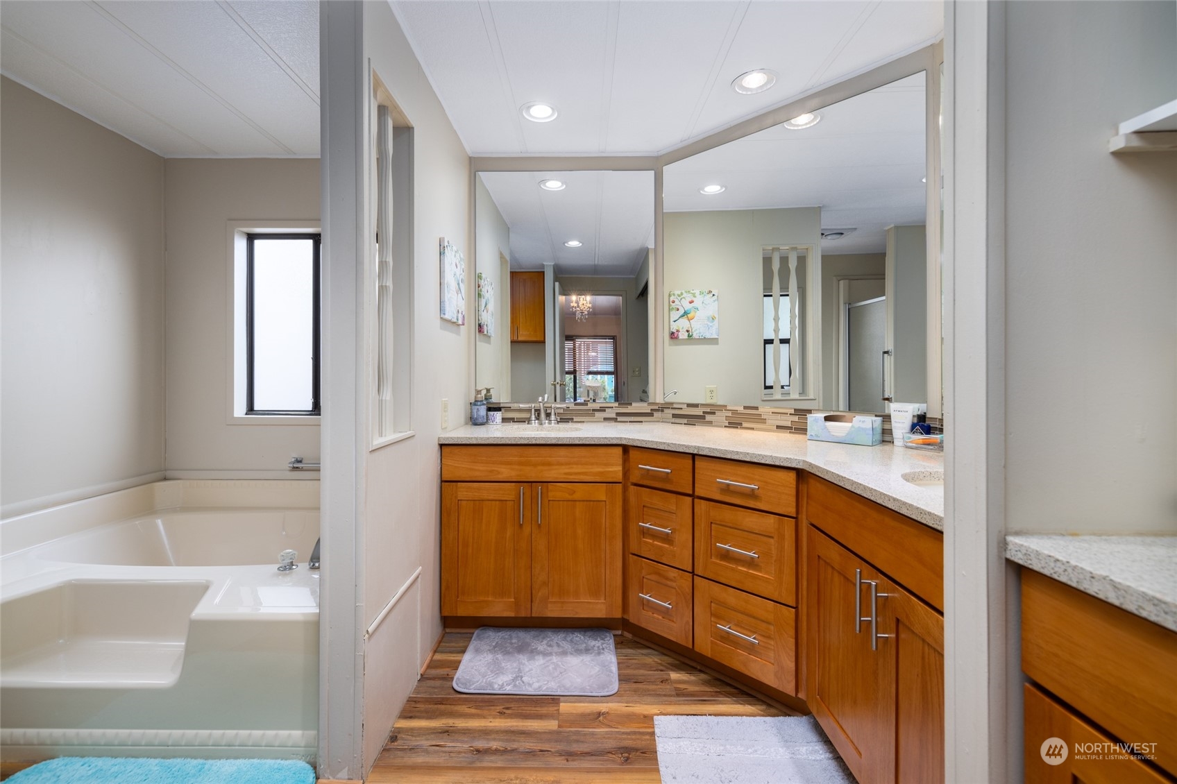 beautifully updated primary bath features dual sinks, shower and soaking tub, and additional storage