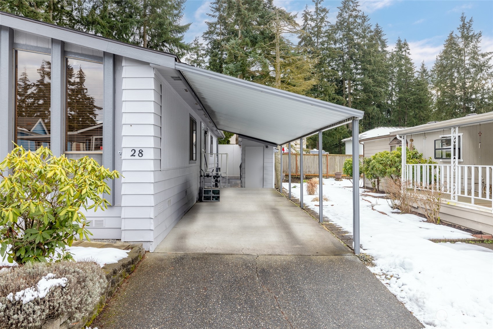 back entrance with carport and storage shed