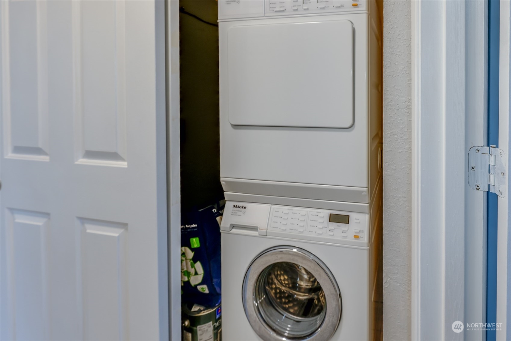 A dedicated laundry space with a convenient stacked washer and dryer. The closet provides efficient storage to keep everything organized.