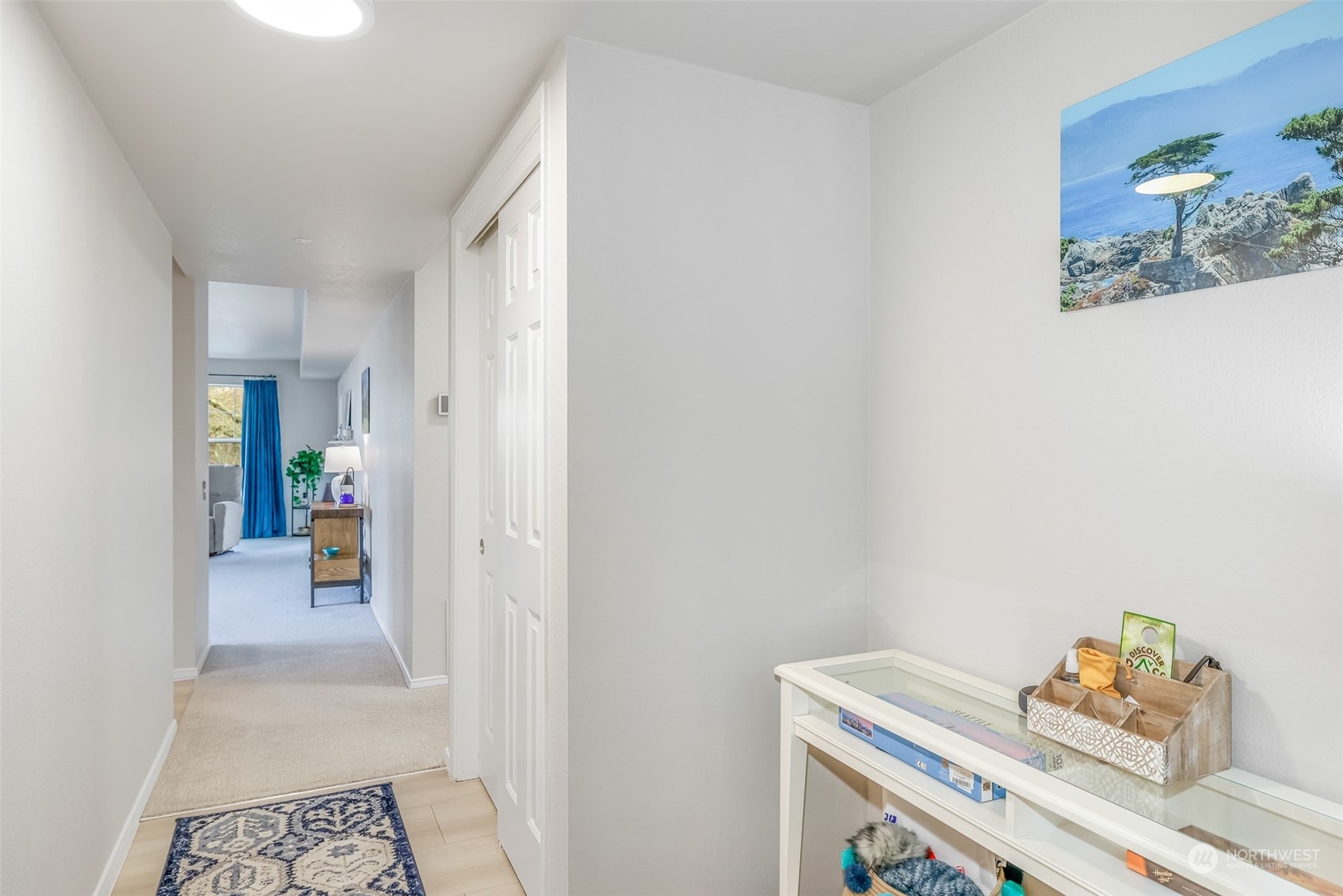 The spacious hallway introduces you to the beautifully remodeled interior, with fresh paint and updated flooring enhancing the modern feel. Ample lighting and an open flow make the space feel expansive and airy, offering a seamless transition into the heart of the home.