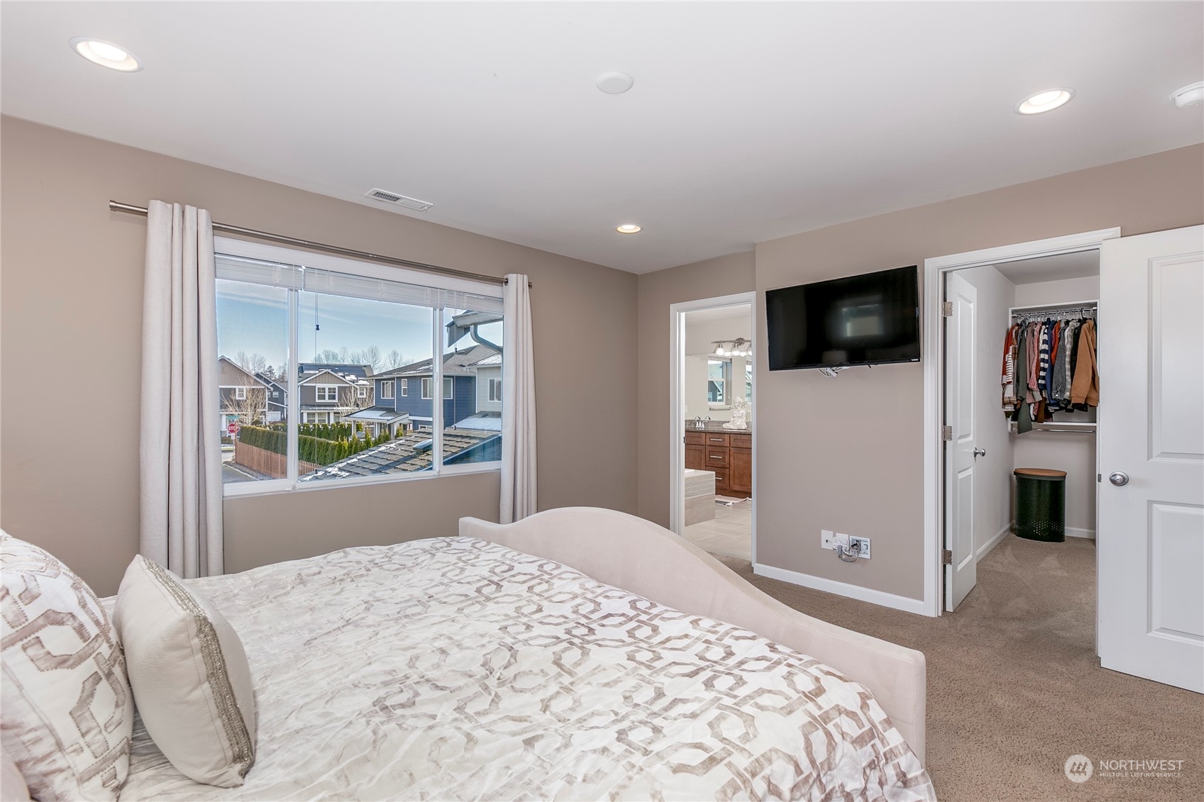 Primary bedroom with large bathroom and walk-in closet.