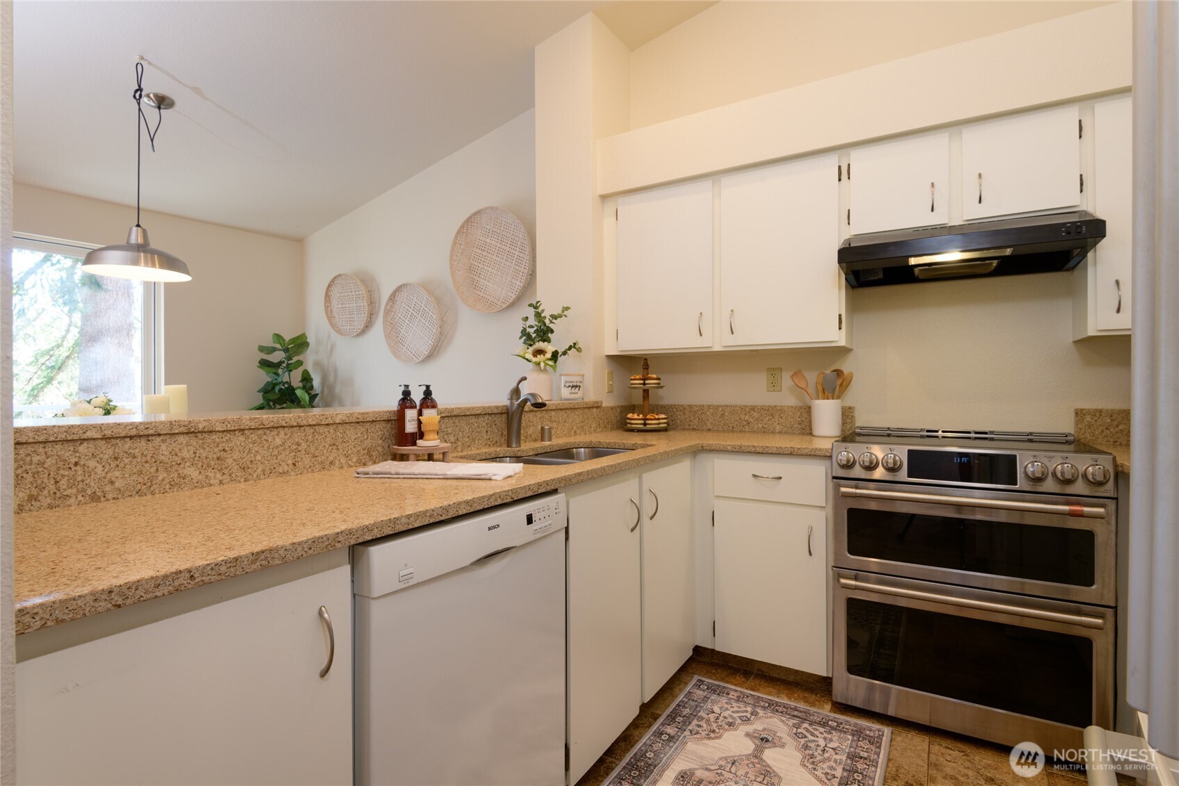 The kitchen is spacious and offers loads of cabinet space. The open Floor plan ensures you can be in the kitchen and still enjoy those gorgeous PNW mountain views. Newer double oven. Quartz counters and ceramic tile floors.and still enjoy interactions throughout the main living area.