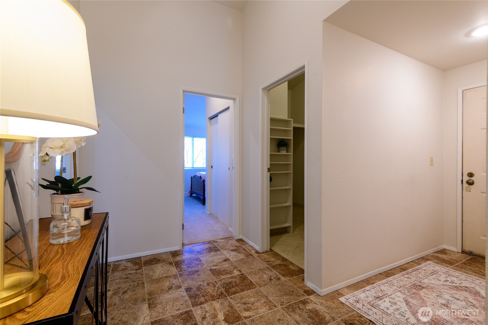 From the entry, this view is looking to the laundry room at right and two of th three bedrooms.