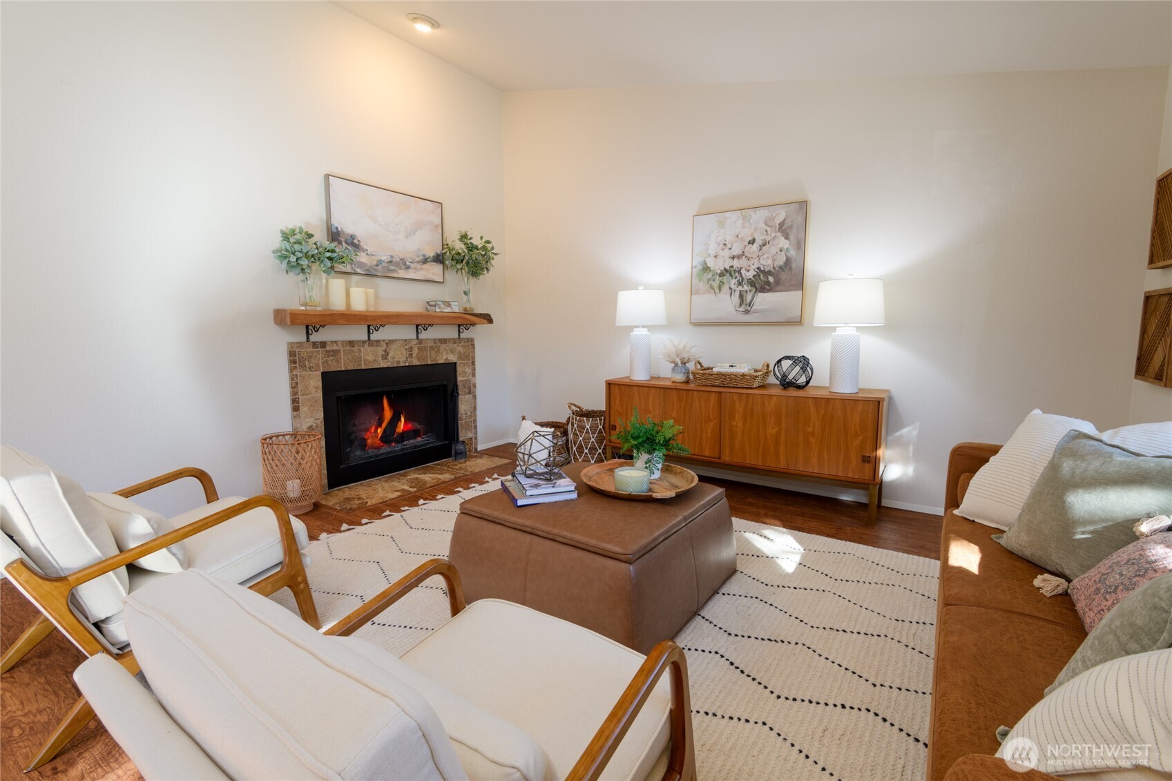 The fireplace provides warmth and a cozy atmosphere to the living room on chilly Winter days.