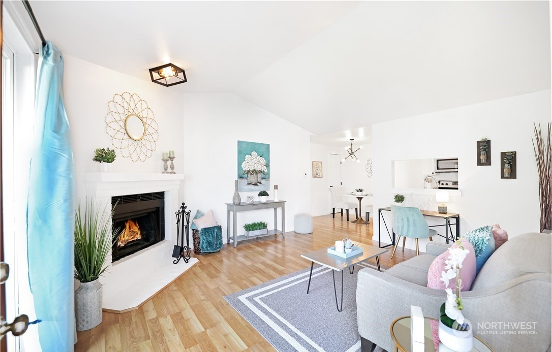 Living room. Photo includes staging, unit currently vacant.