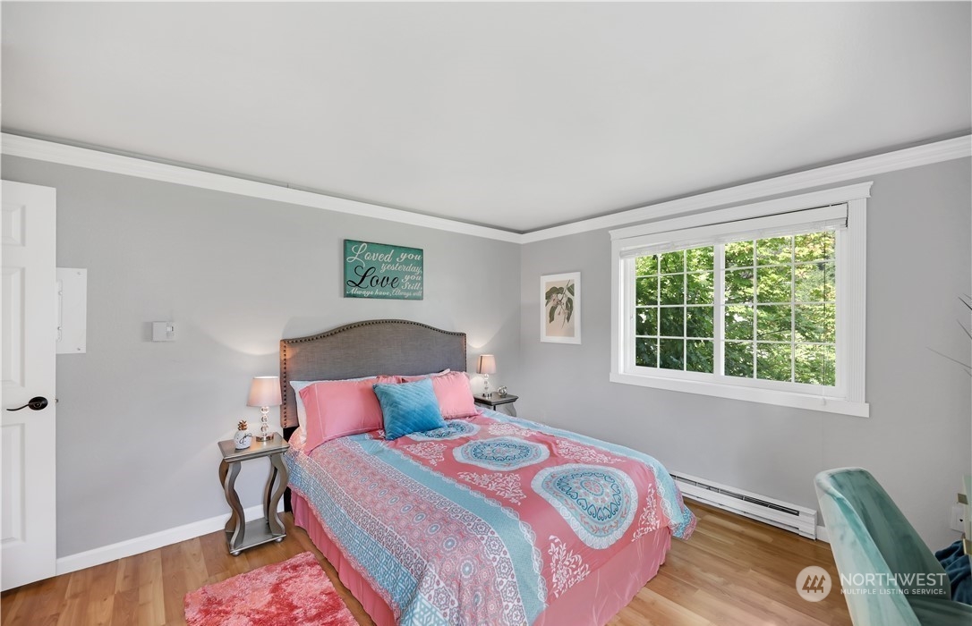 Bedroom. Photo includes staging, unit currently vacant.