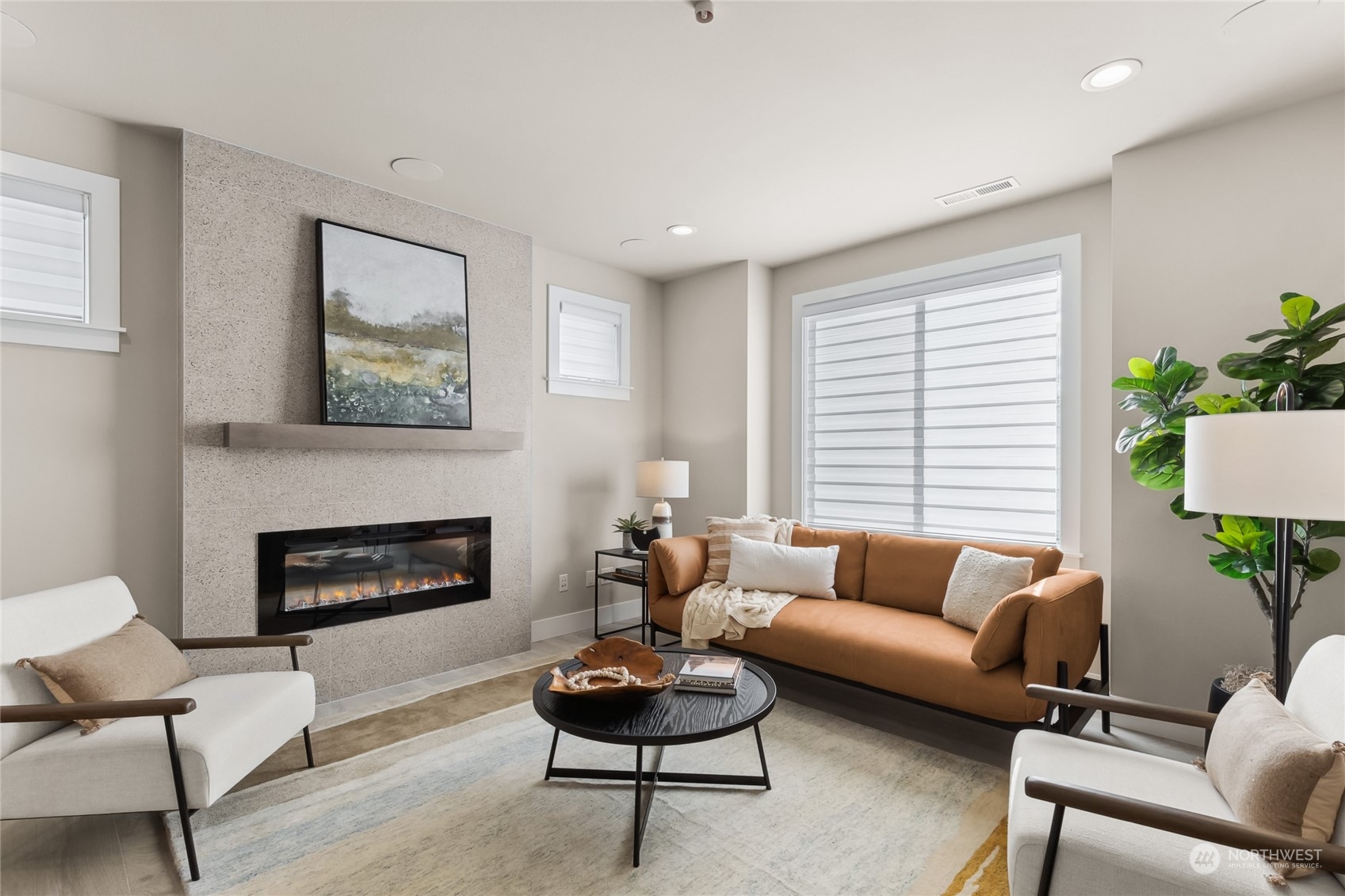 The family room has a large window and plenty of room to relax and unwind with a wall mounted TV location, surround sound in the ceiling, and an electric fireplace for ultimate enjoyment.