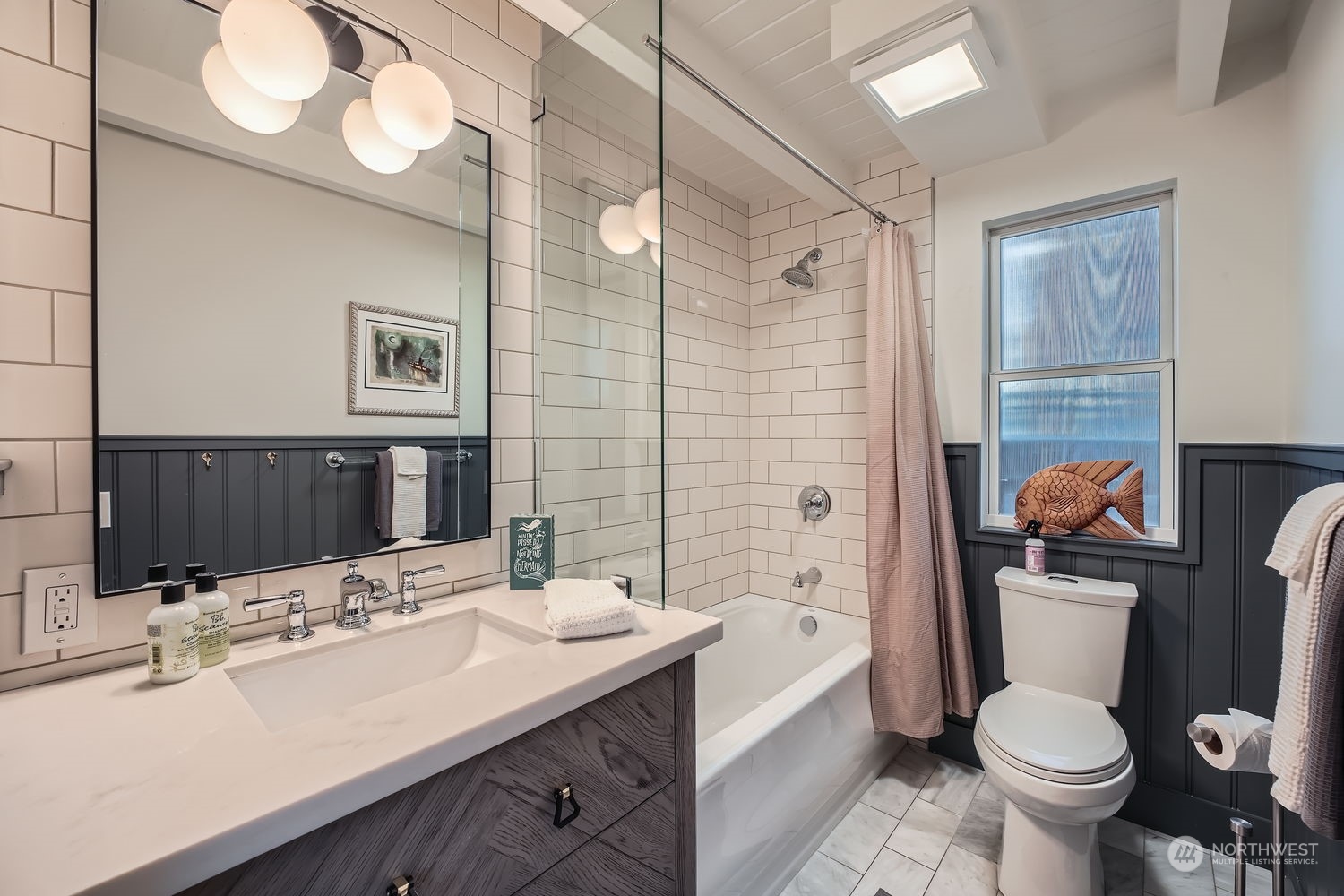 Tile flooring and wainscoting compliments the walls.