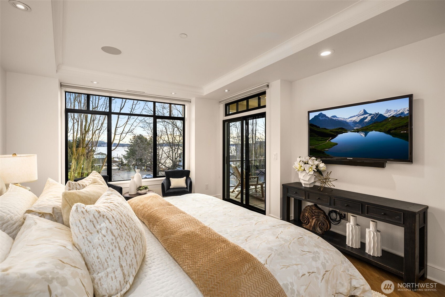 Large cozy primary bedroom looks out over the water.