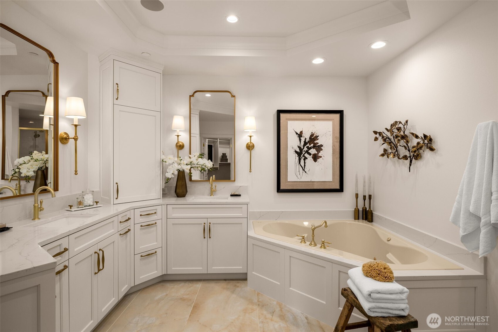 Luxurious primary bath with jet tub, custom cabinetry and large shower.