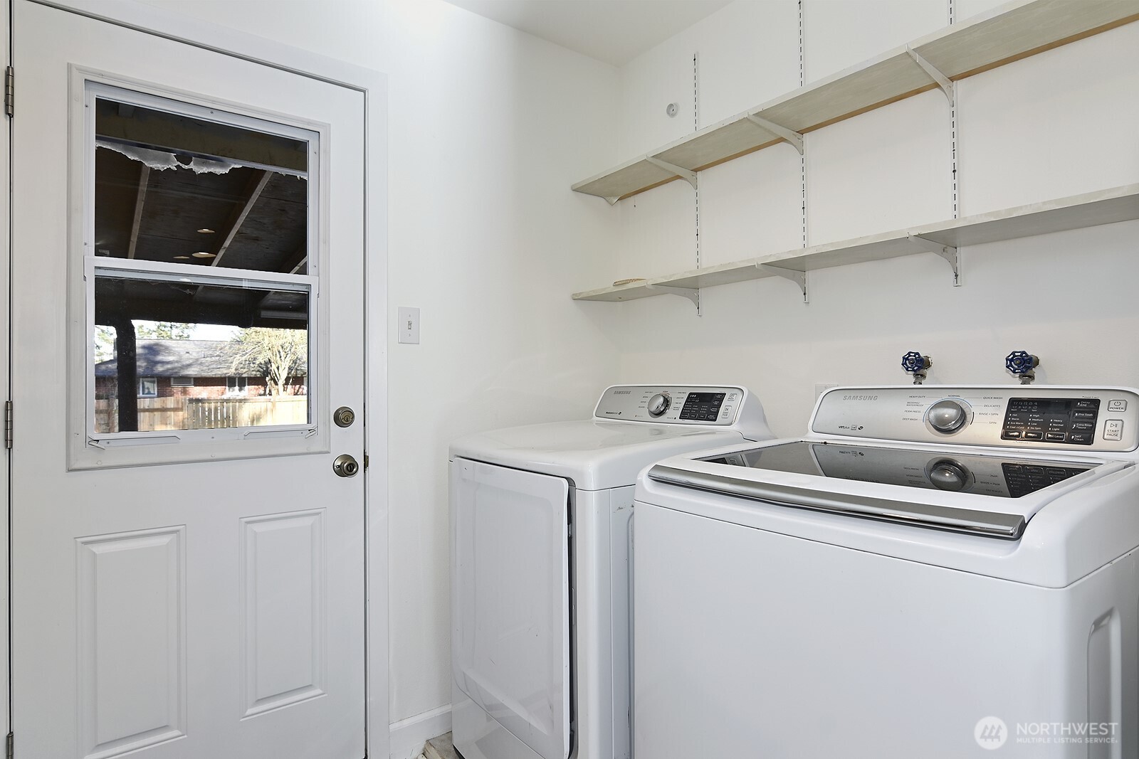 Convenient laundry room with large storage area.