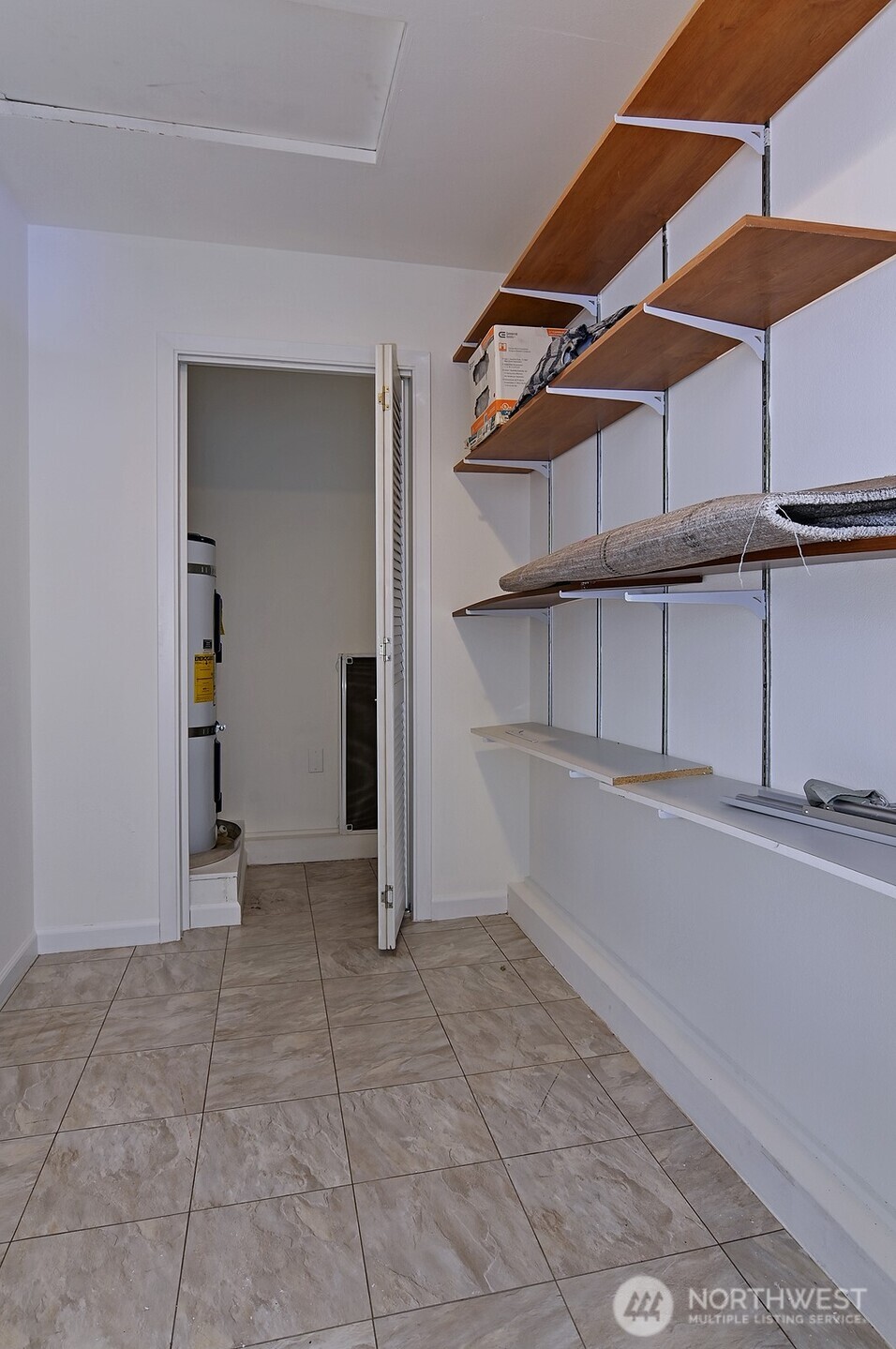 Convenient laundry room with large storage area.