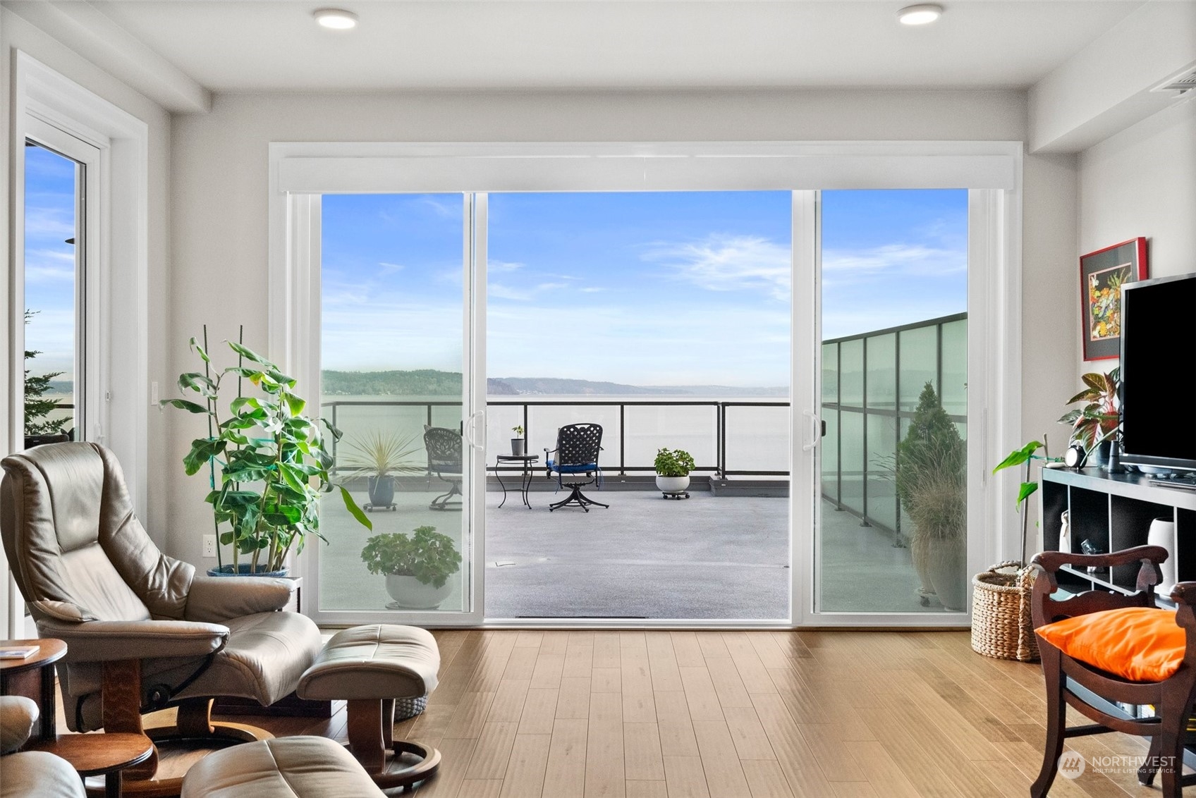 The living room is flooded with natural light with easy access to the deck