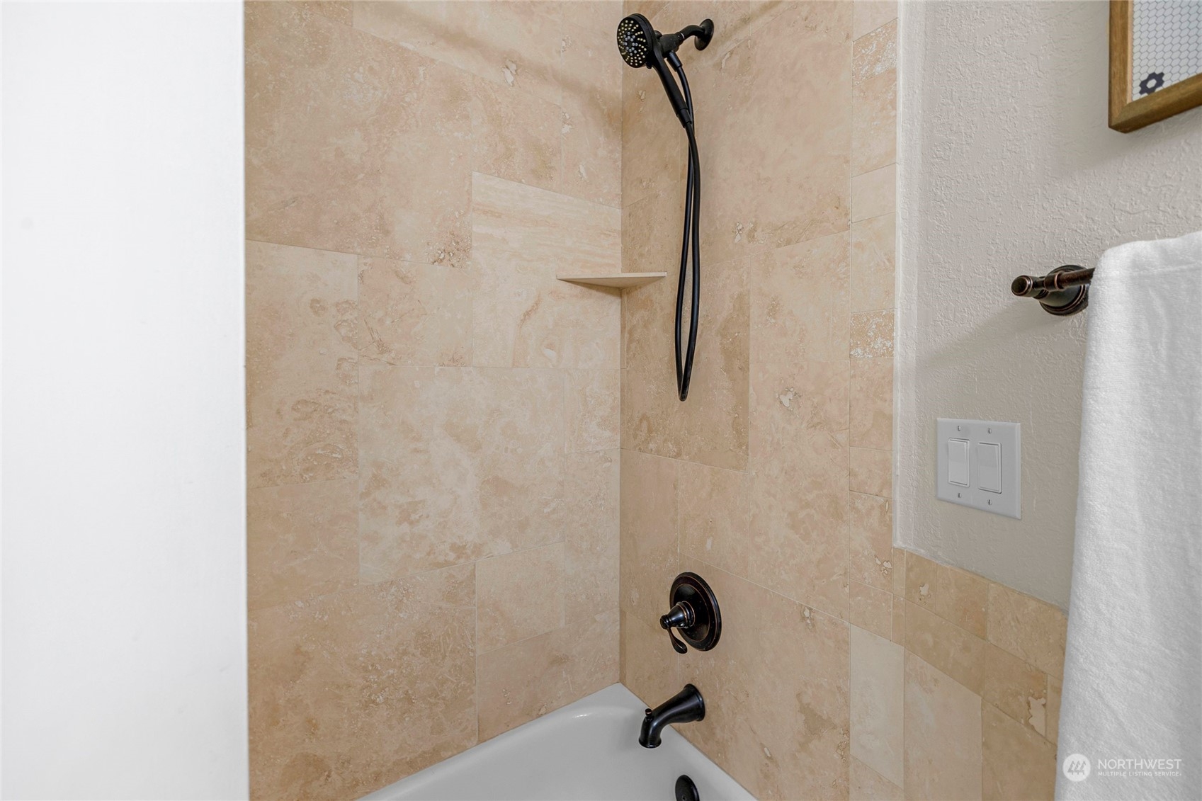 Full hall bathroom with tile details and updated fixtures