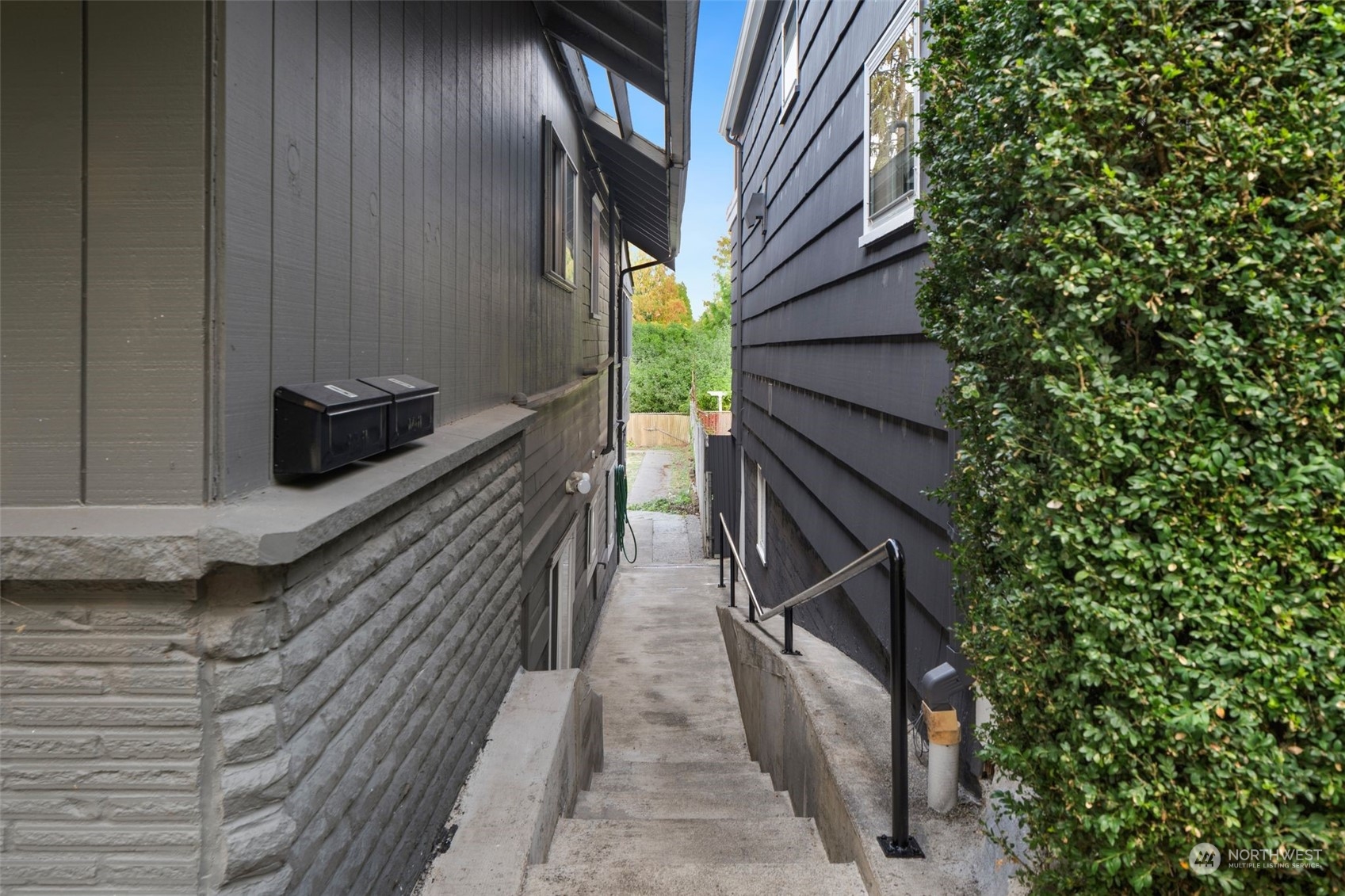 Staircase and pathway on south side of home leading to unit B from North Lawrence Street. Separate mailboxes and addresses for unit A and unit B.