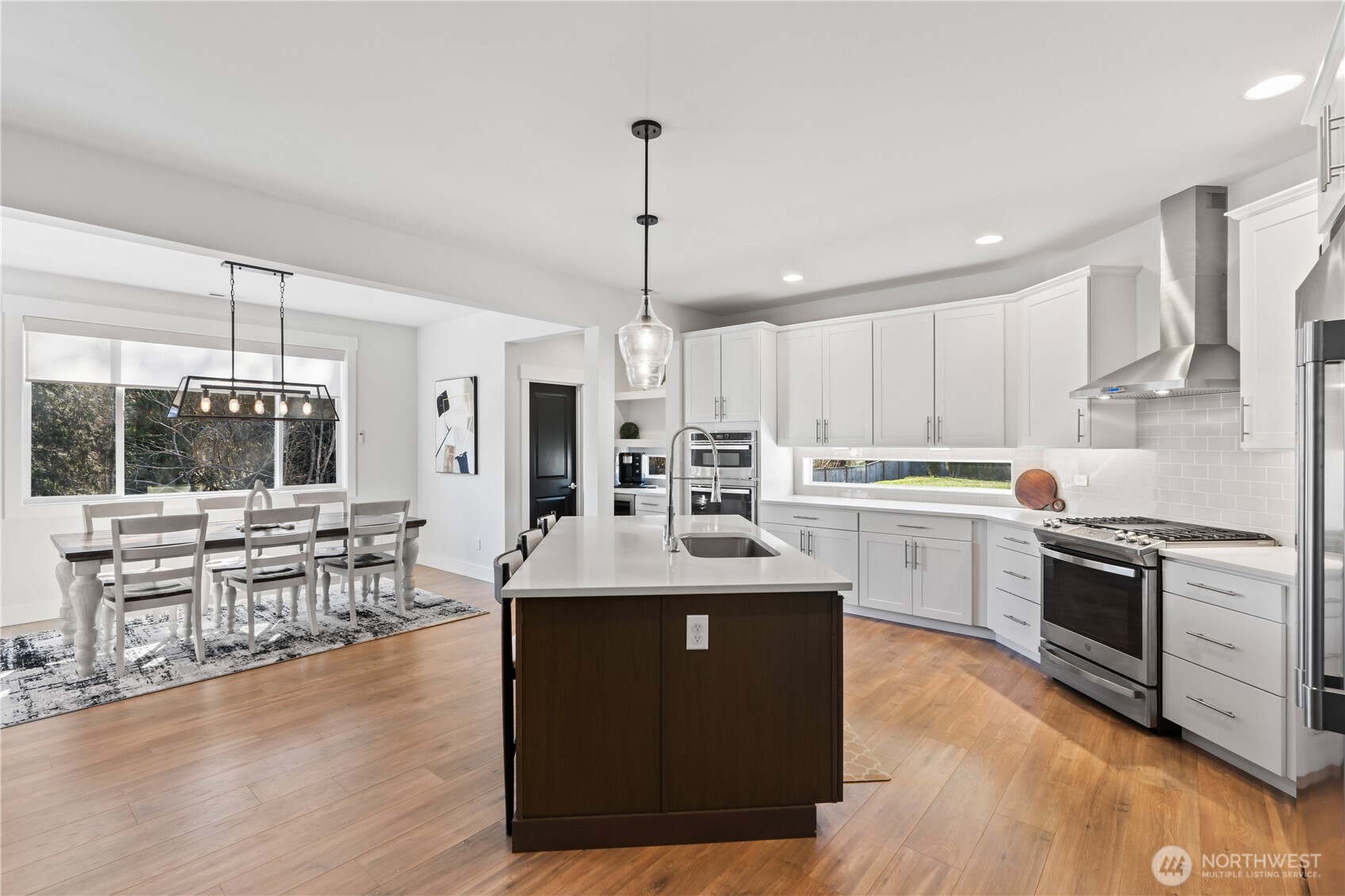 Living room showcases brick-framed gas fireplace and custom built in cabinetry.