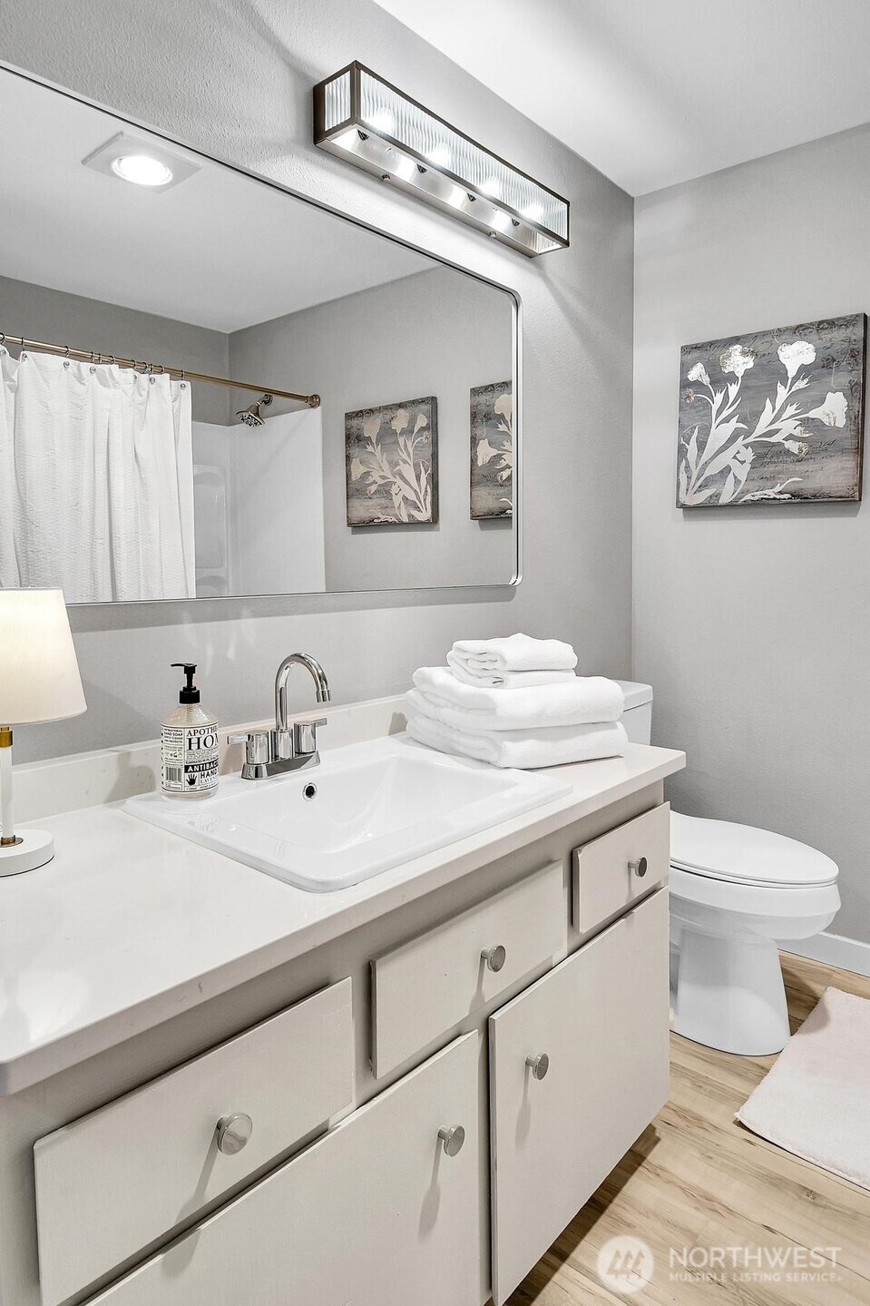 Spacious full bath also offers new quartz counters, sink, toilet and lighting.