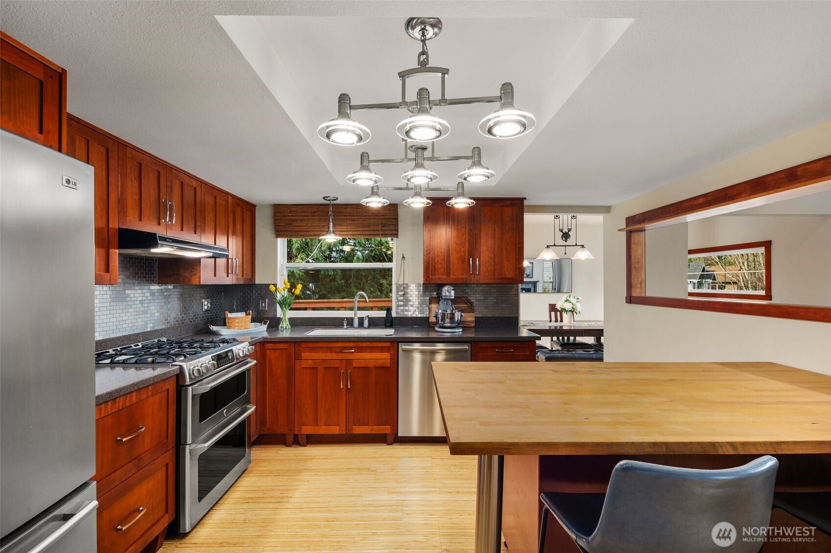 Stainless steel appliances with sitting area.