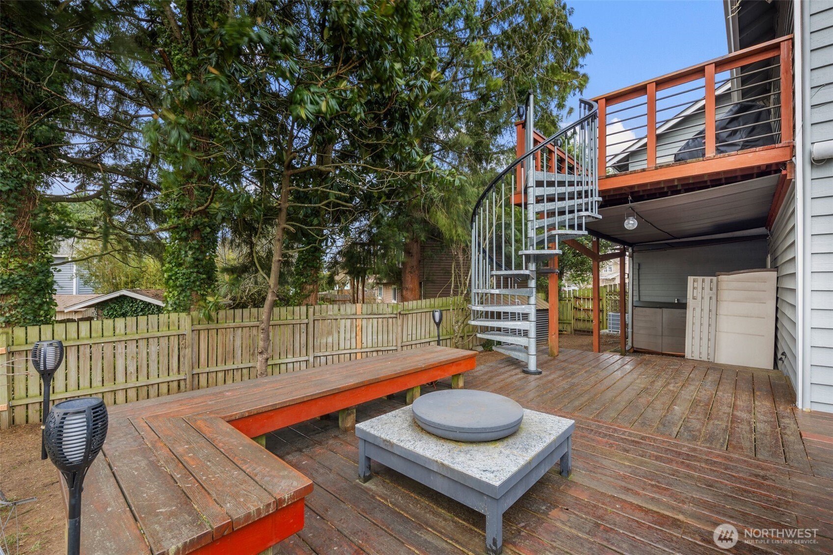 Spiral stairs from upper porch going down to main deck