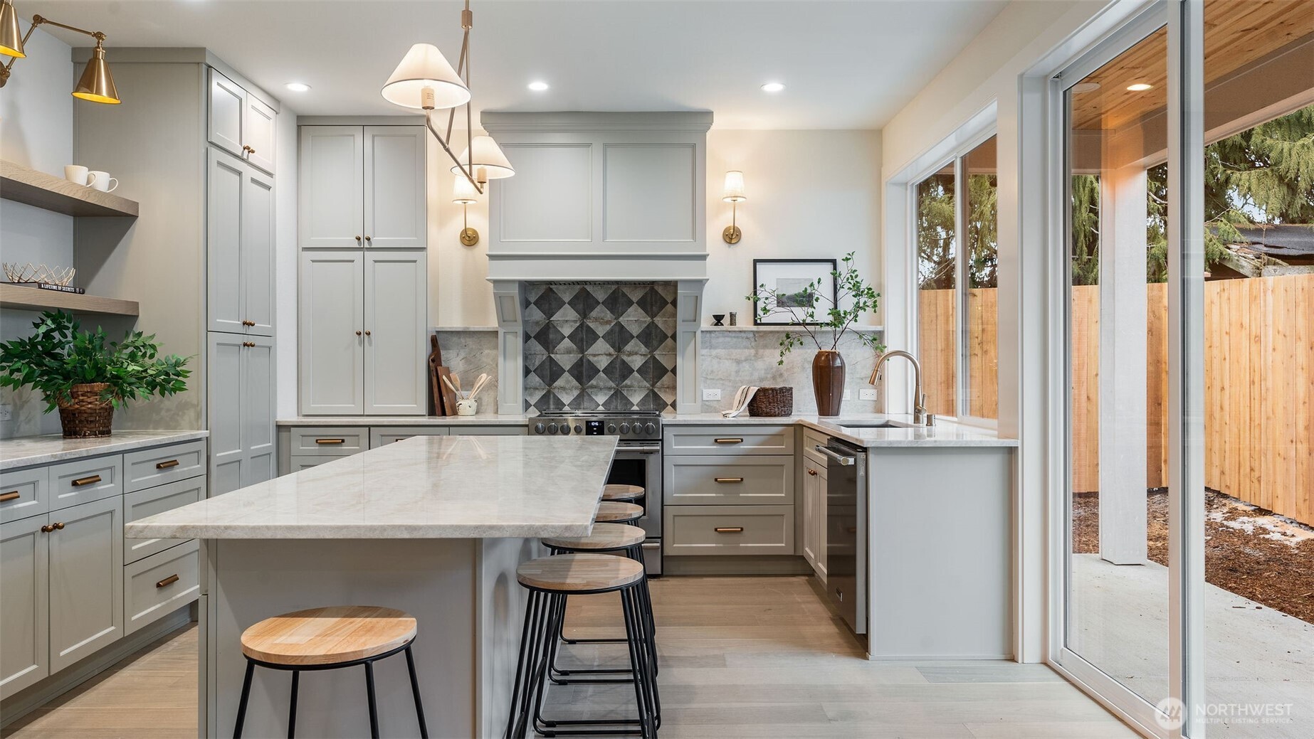 Kitchen has large Island with Seating and open to covered patio.