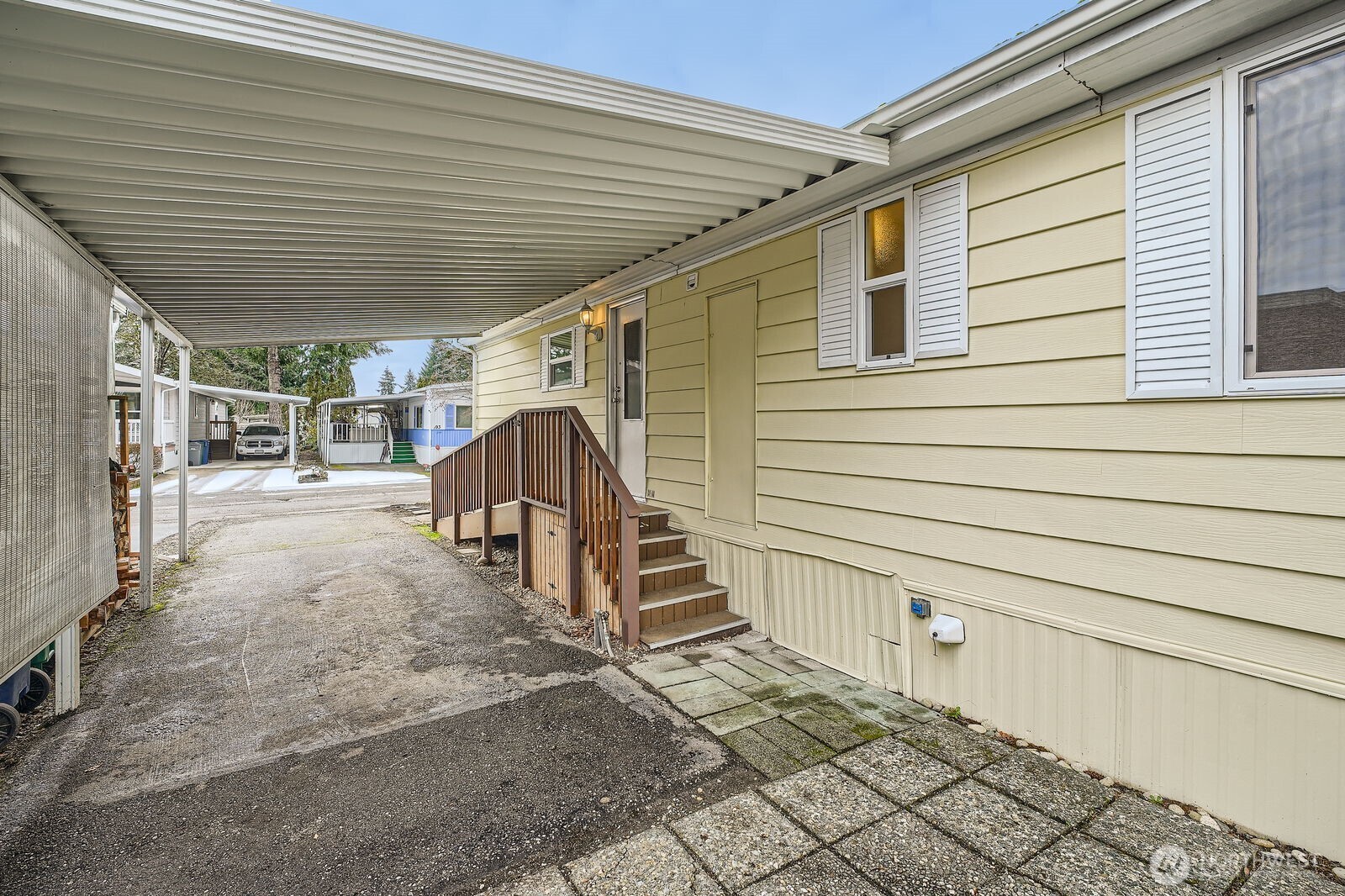 Large covered carport easily fits two cars