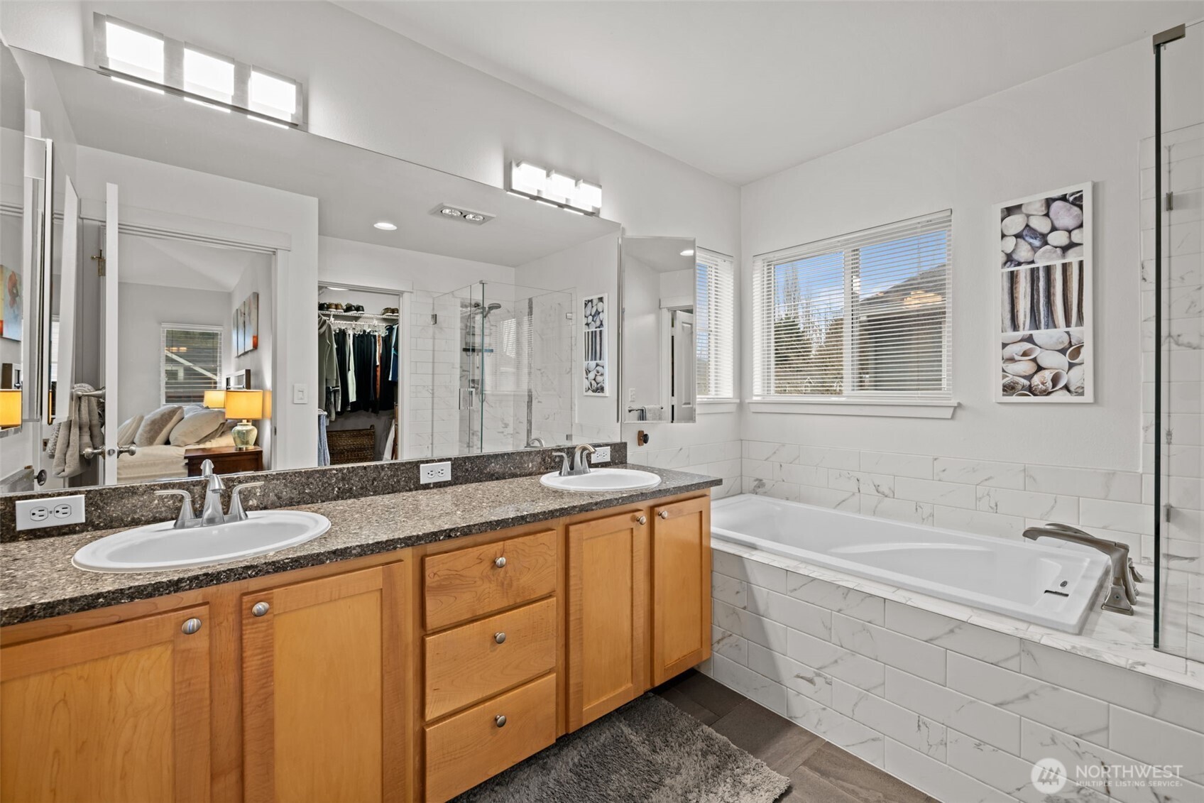 Updated primary 5 piece bath with tile surround, quartz counters, new fixtures and tile floors