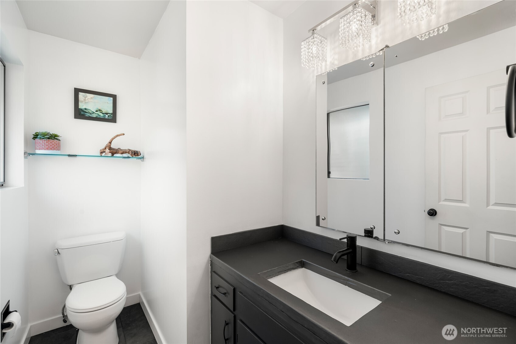 New floor tiles and a custom cement countertop modernize the powder room.