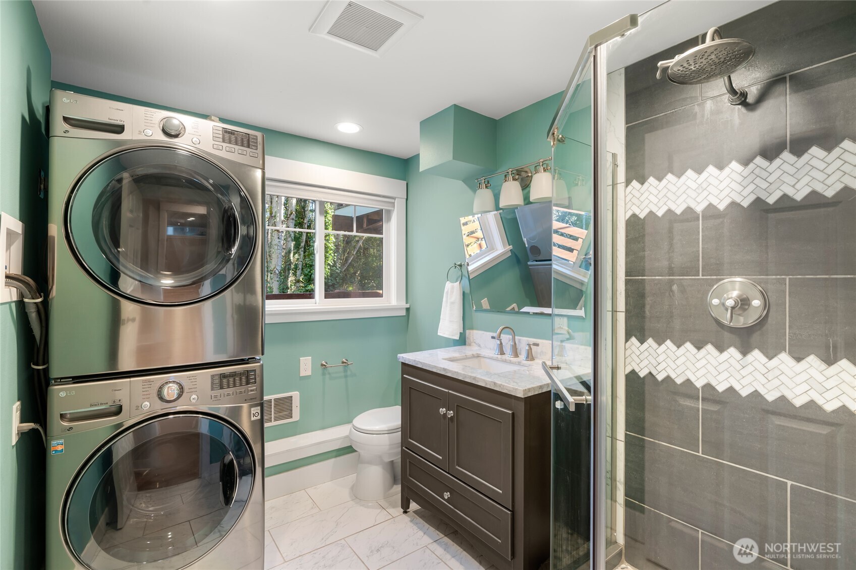 Stack washer and dryer in downstairs bath.