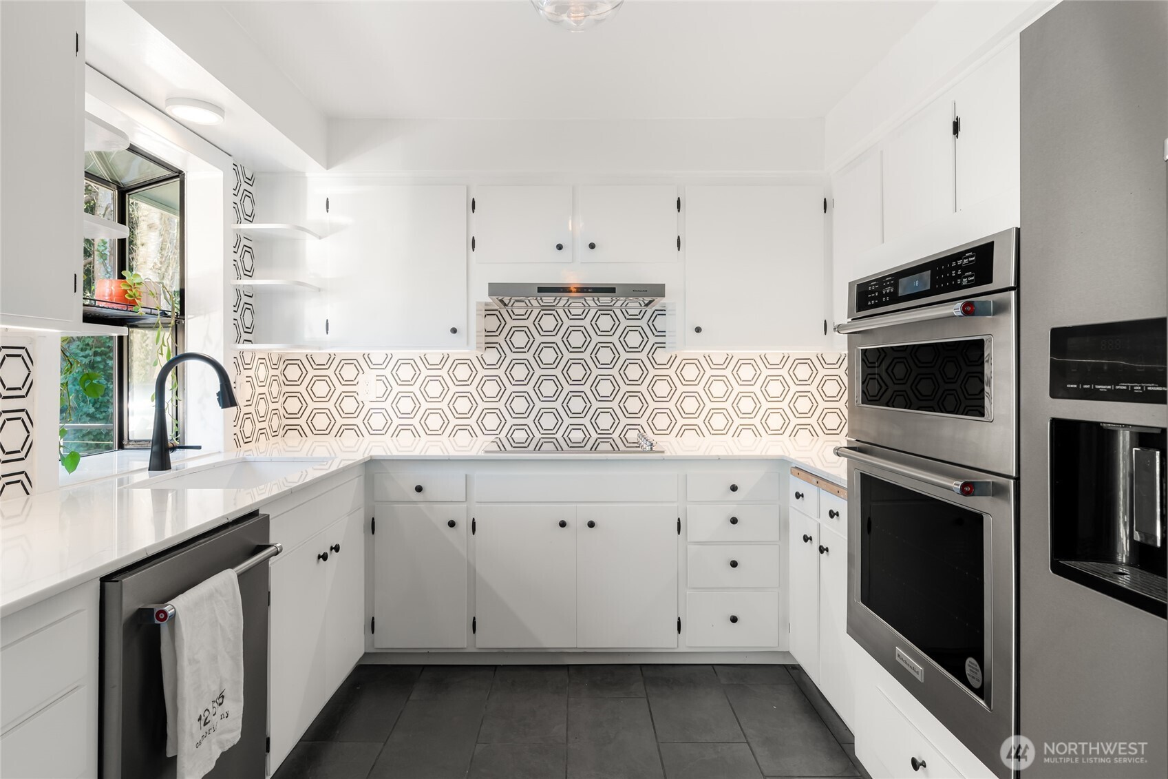 New tile floor and backsplash, refinished cabinetry, new hardware.