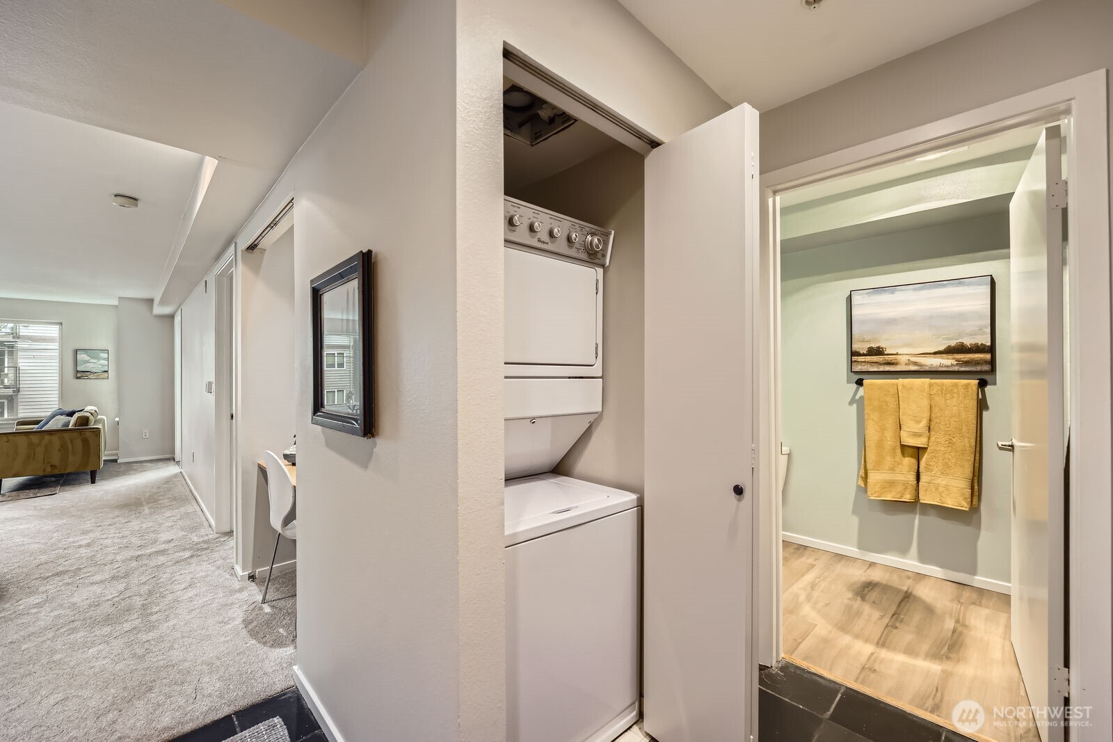 Entryway with slate floors, entry closet, and larger storage closet plus n unit laundry