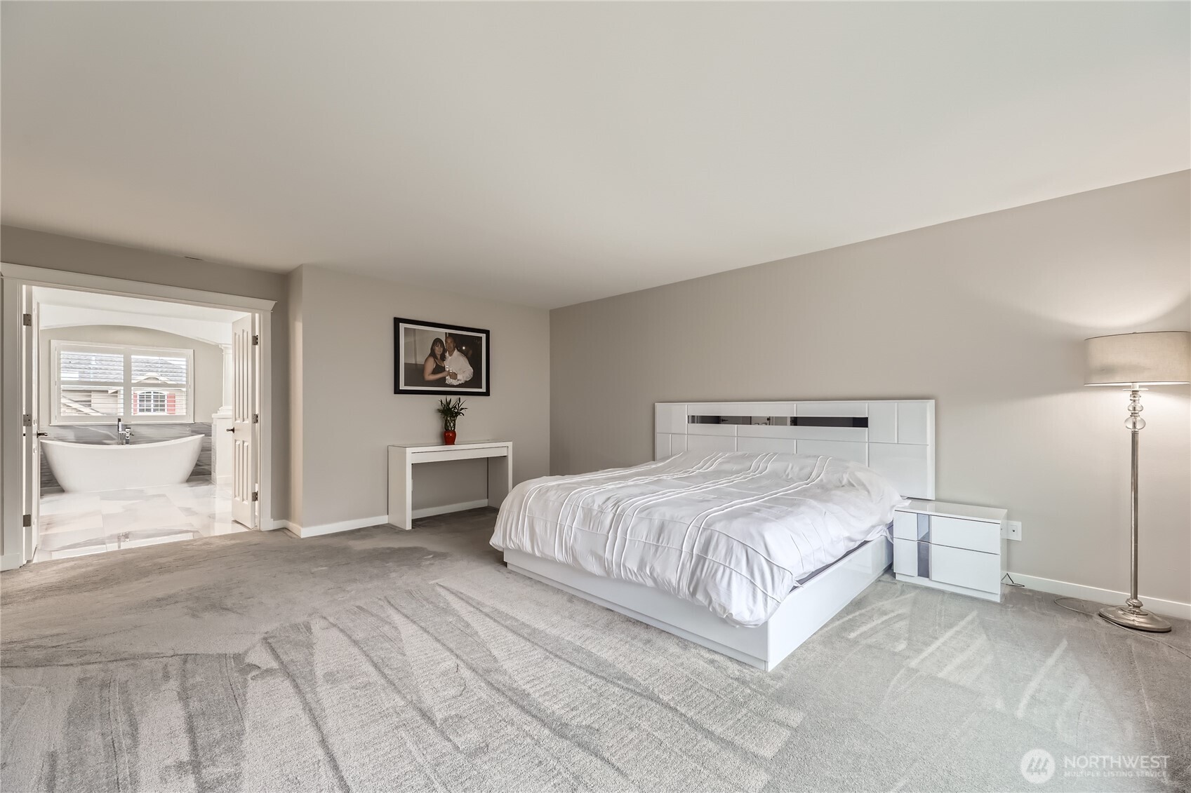 Double doors off the primary bedroom lead to a luxurious bath.