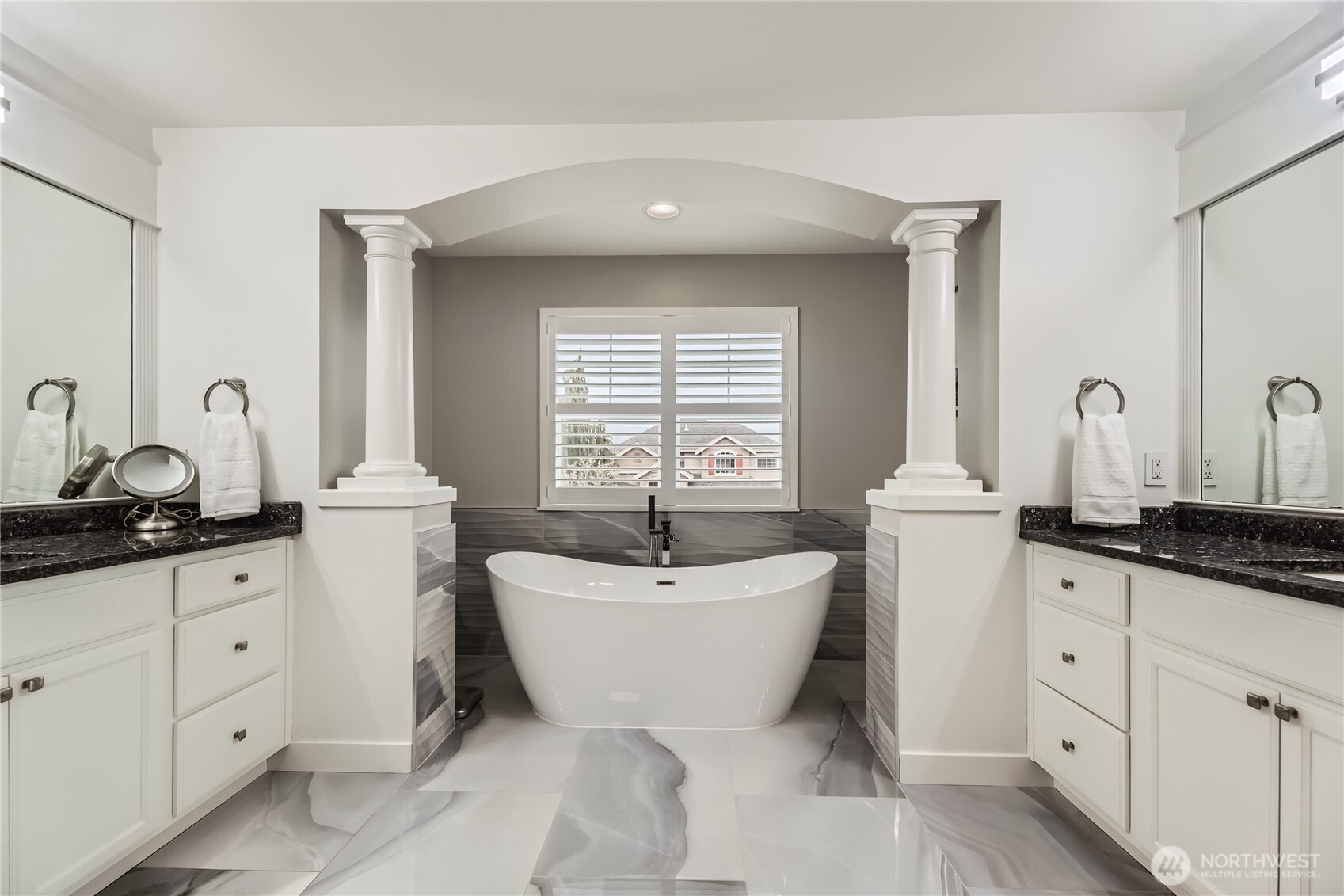 The primary bath is a true spa experience with a new tub flanked by column accents, large step-in shower, dual sinks, heated tile flooring, and an Alexa-controlled fan and speakers.