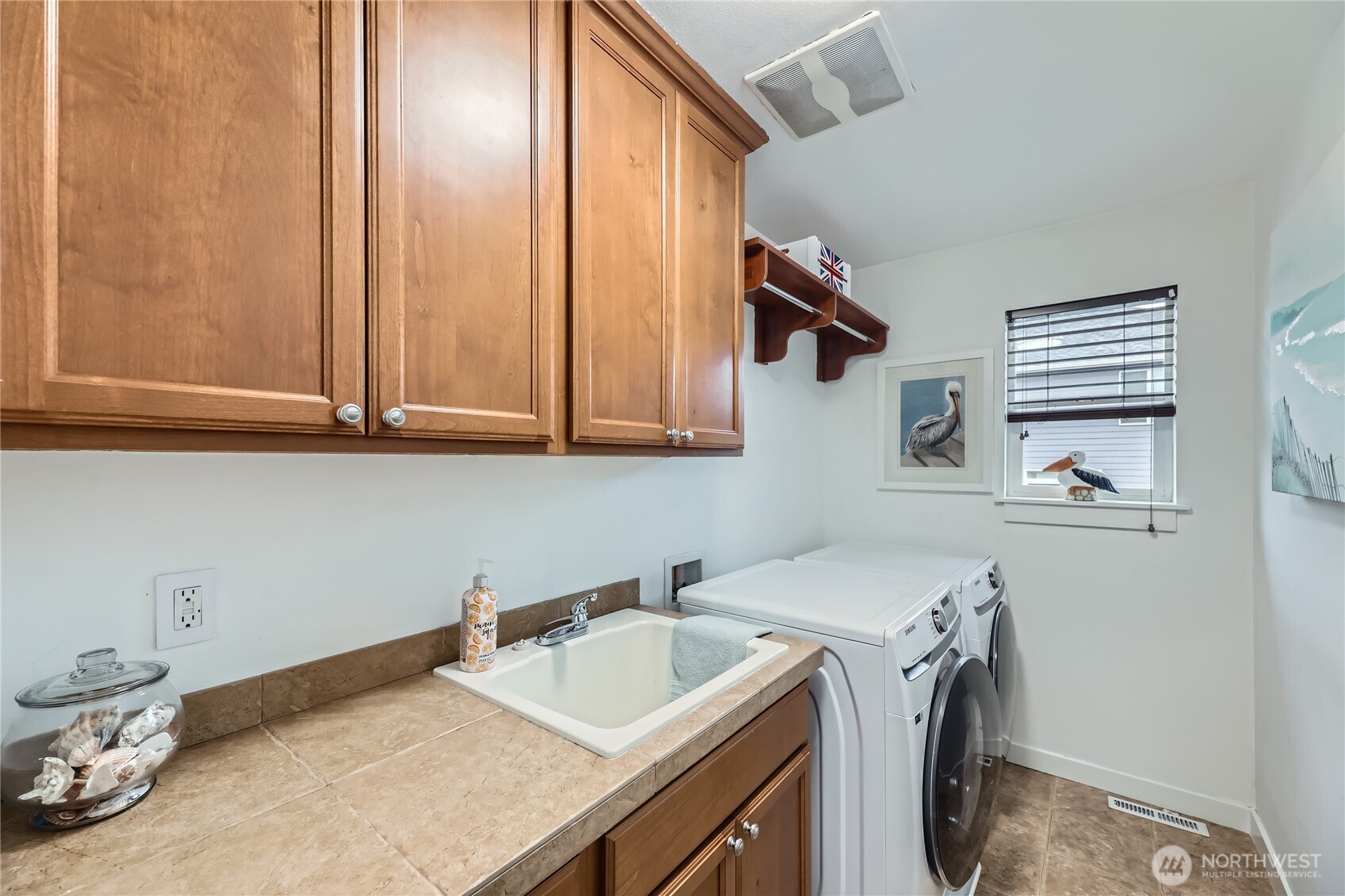 Laundry room with a convenient sink and built-ins for added storage.