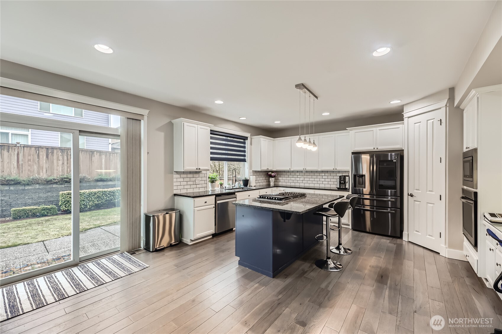 There is room for a casual dining area off the kitchen with a slider that leads to the patio and backyard.