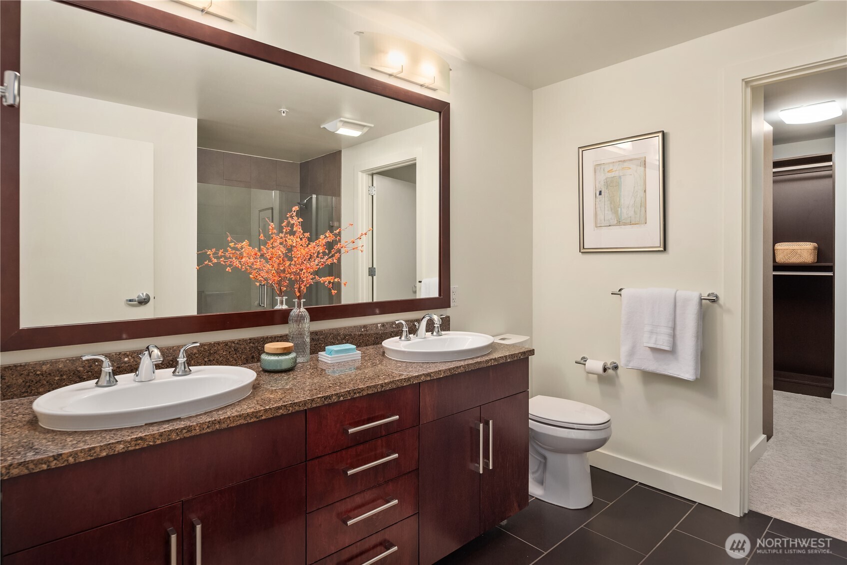 Just beyond the bath is the spacious walk-in closet with extensive California Closets built-ins.