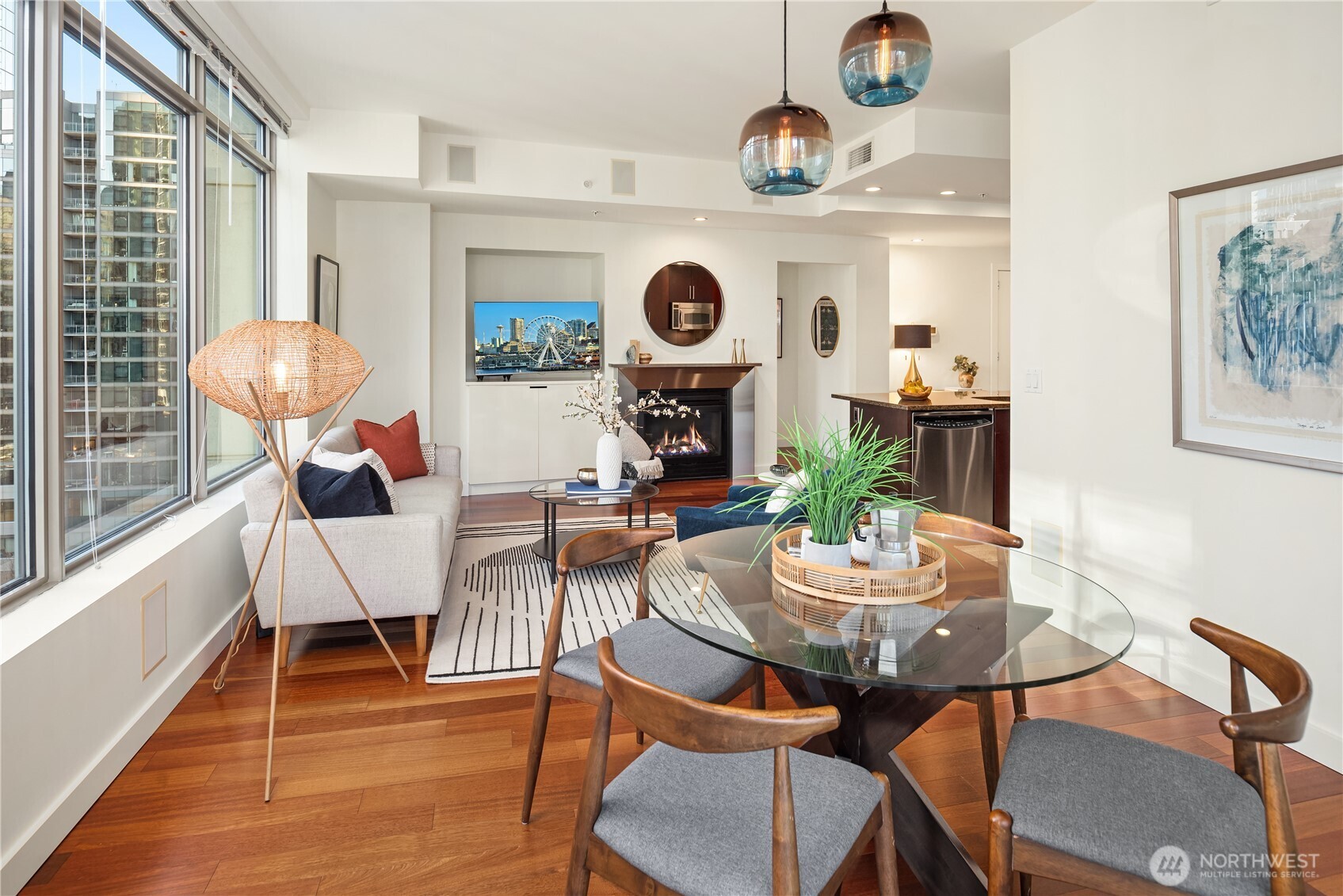 The dining room features hardwood floors and designer lighting.