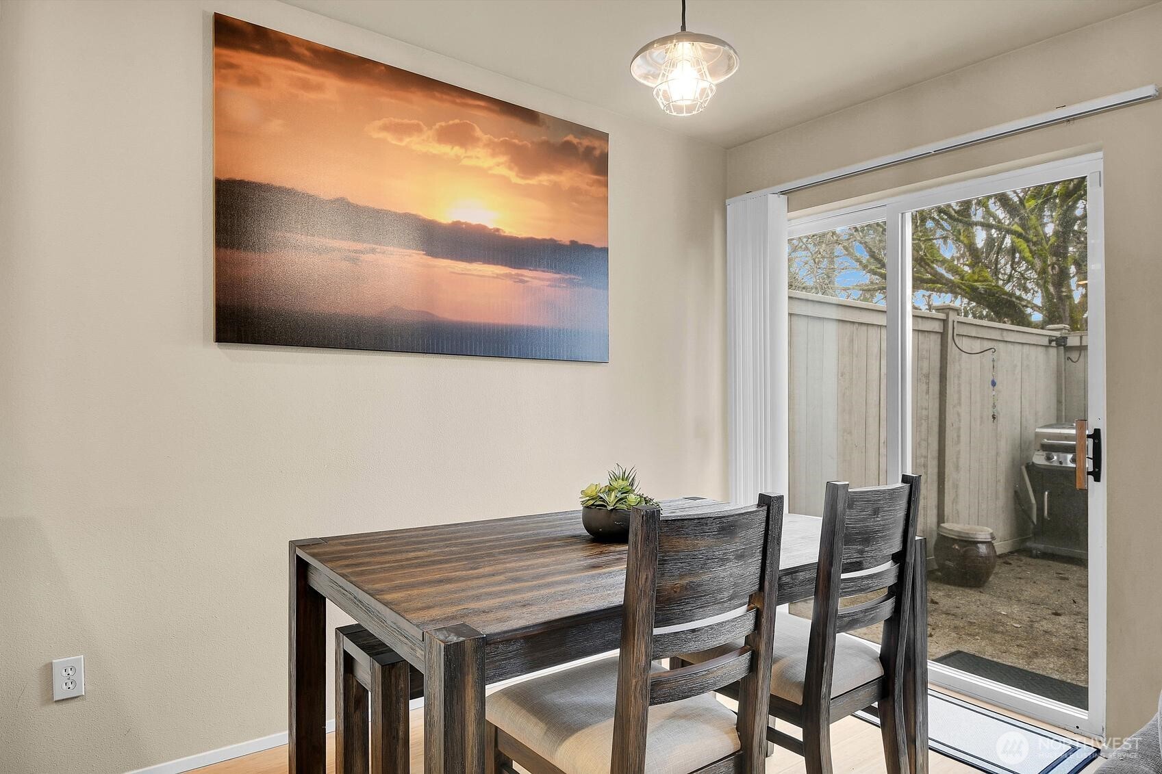 Dining room slider leads to fenced patio area.