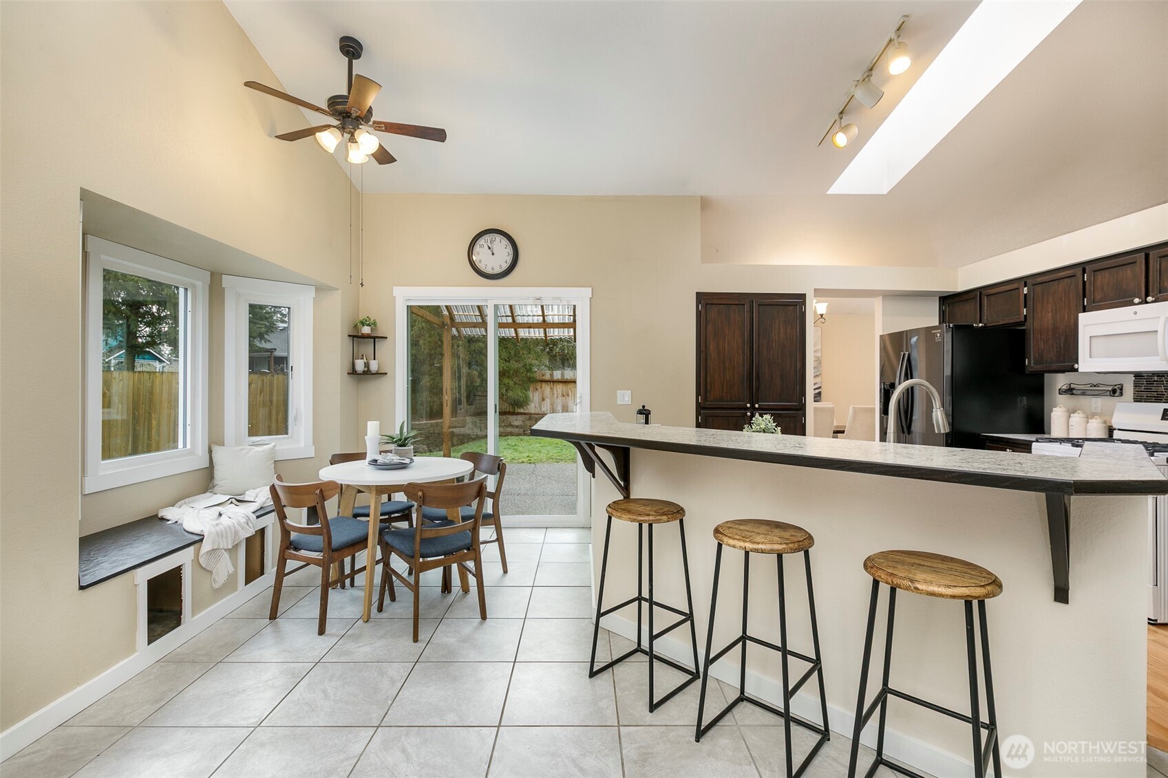 Eating nook w/ bay window, tile floors & backyard views