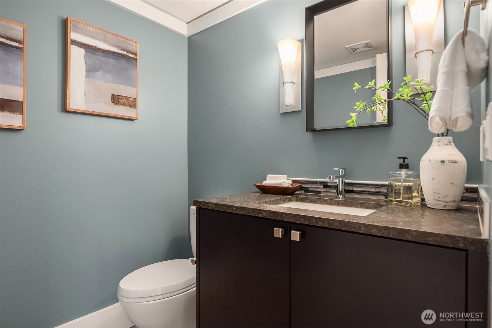 Main floor powder bath room has been tastefully updated with designer colors.