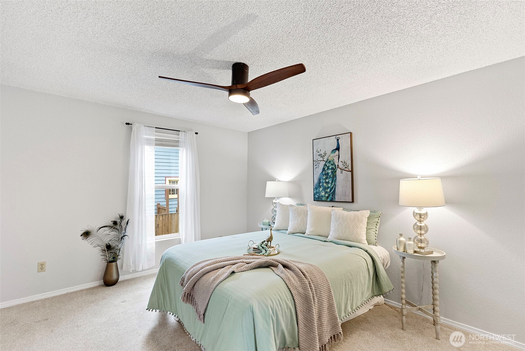 The first of 3 bedrooms offers plenty of space, a ceiling fan, and generous closet space.