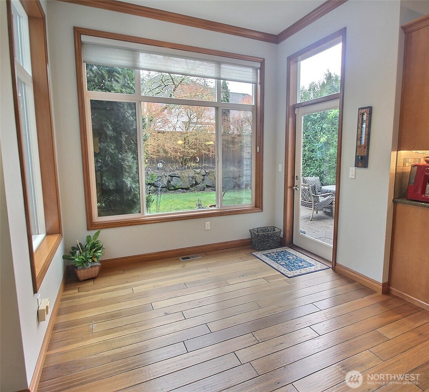 Formal Living room with gas fireplace, wood mantle and marble tiles surrounding it. Crown & Cove Molding and Wainscoting decorate this comfortable room.