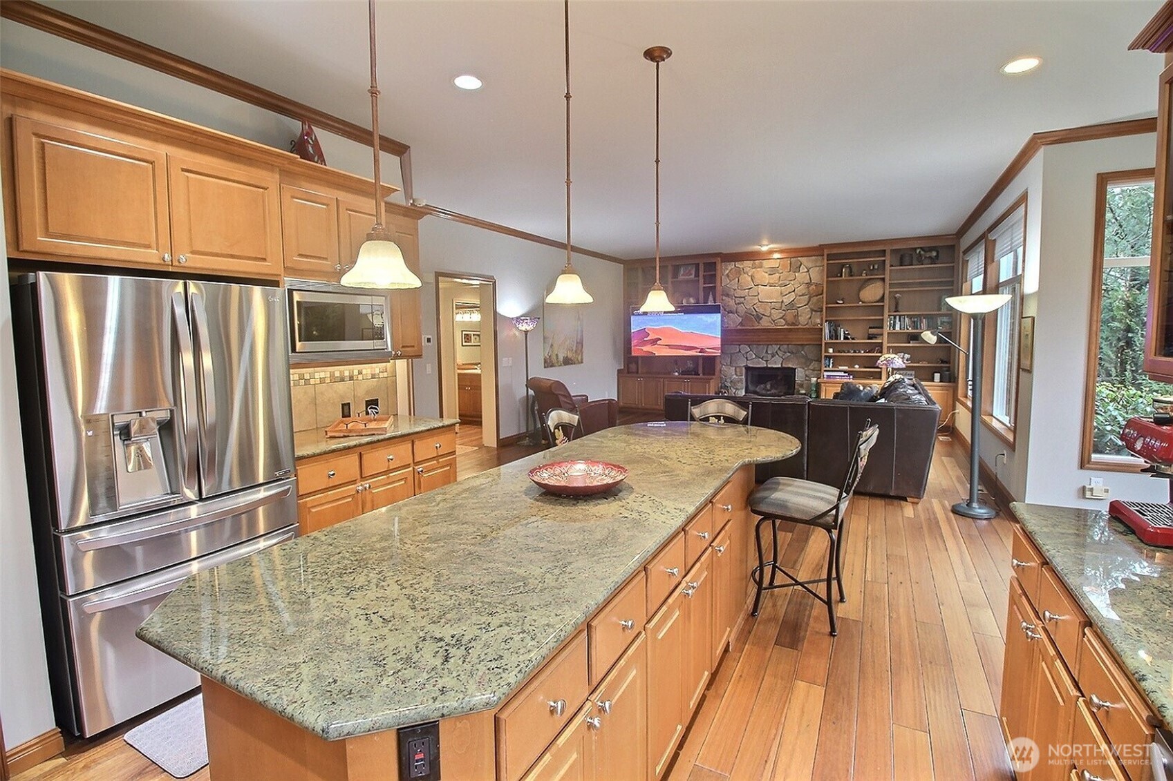 The other half of the Great Room. Built-in Bookcase, rock Fireplace center, just about floor to ceiling windows, 10' ceilings!