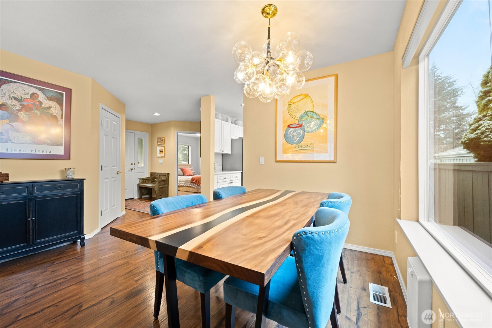 In the dining area looking toward the entry door, second bedroom and kitchen.