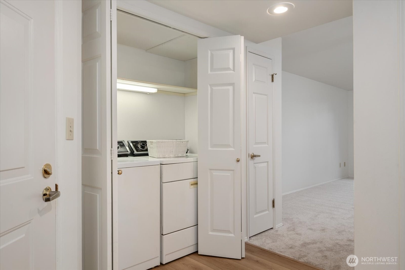 Utility closet with full washer and dryer.